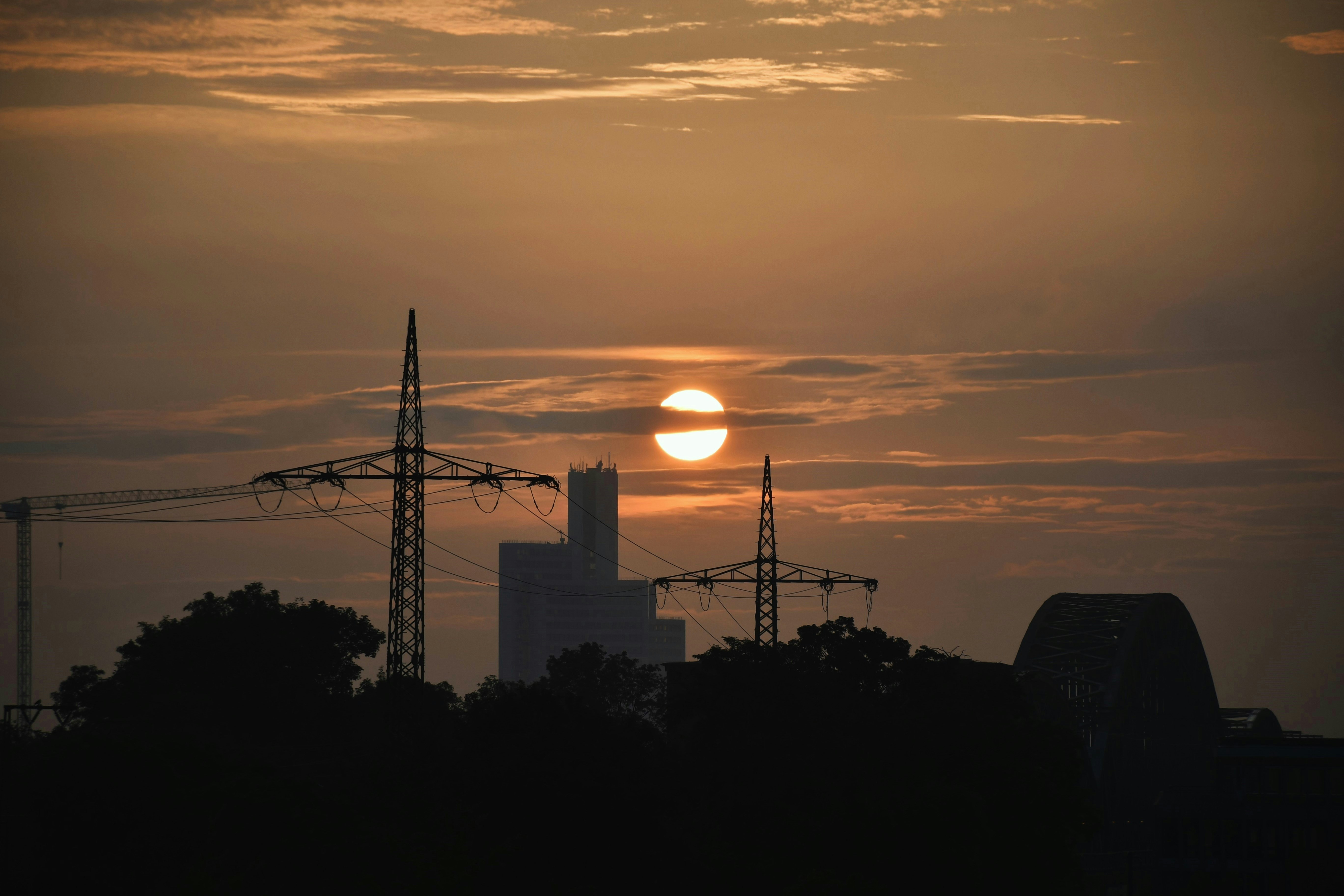 The sun is setting over a city skyline