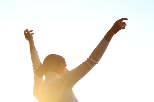 A woman raising her arms in the air