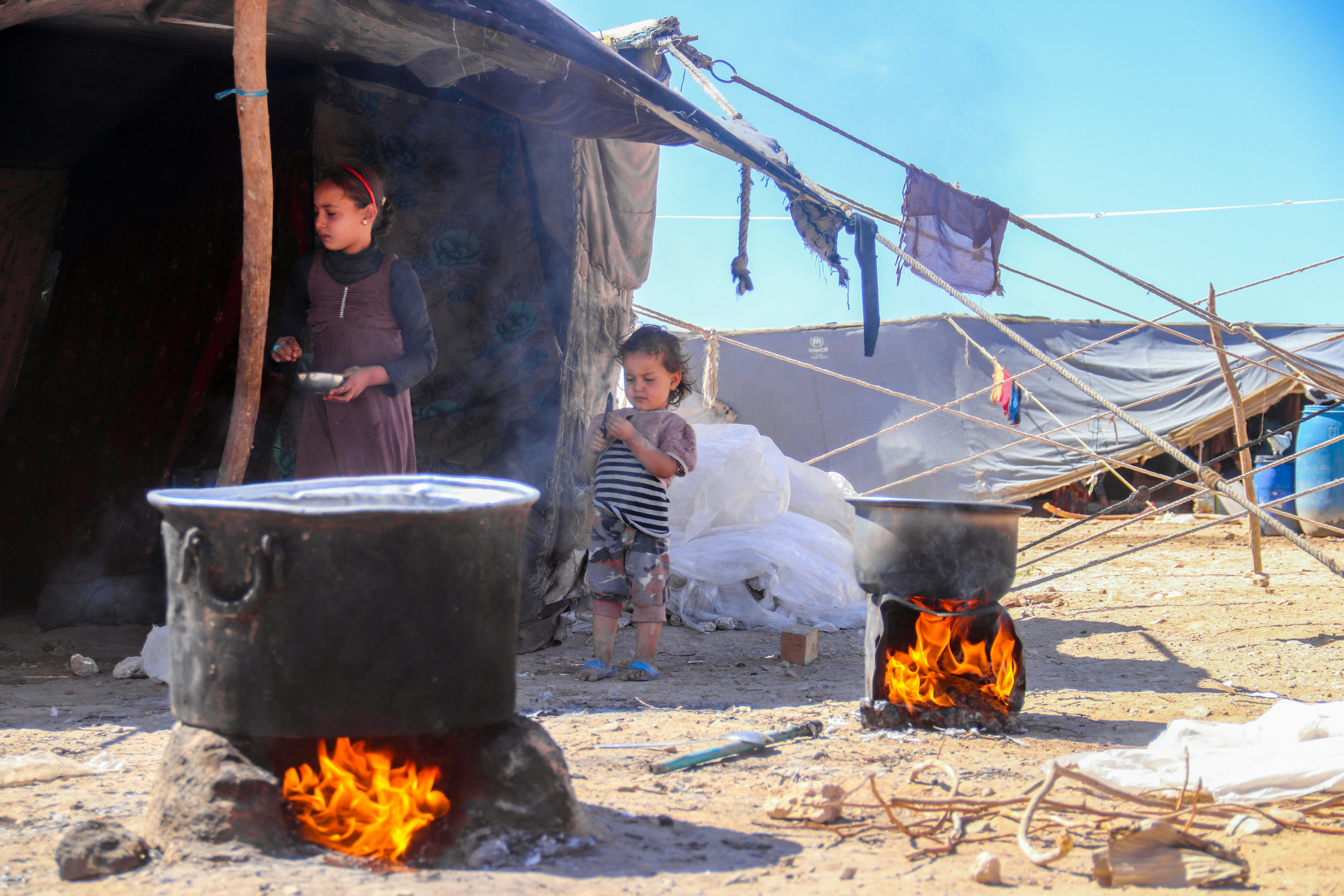 A group of people standing around a fire pit