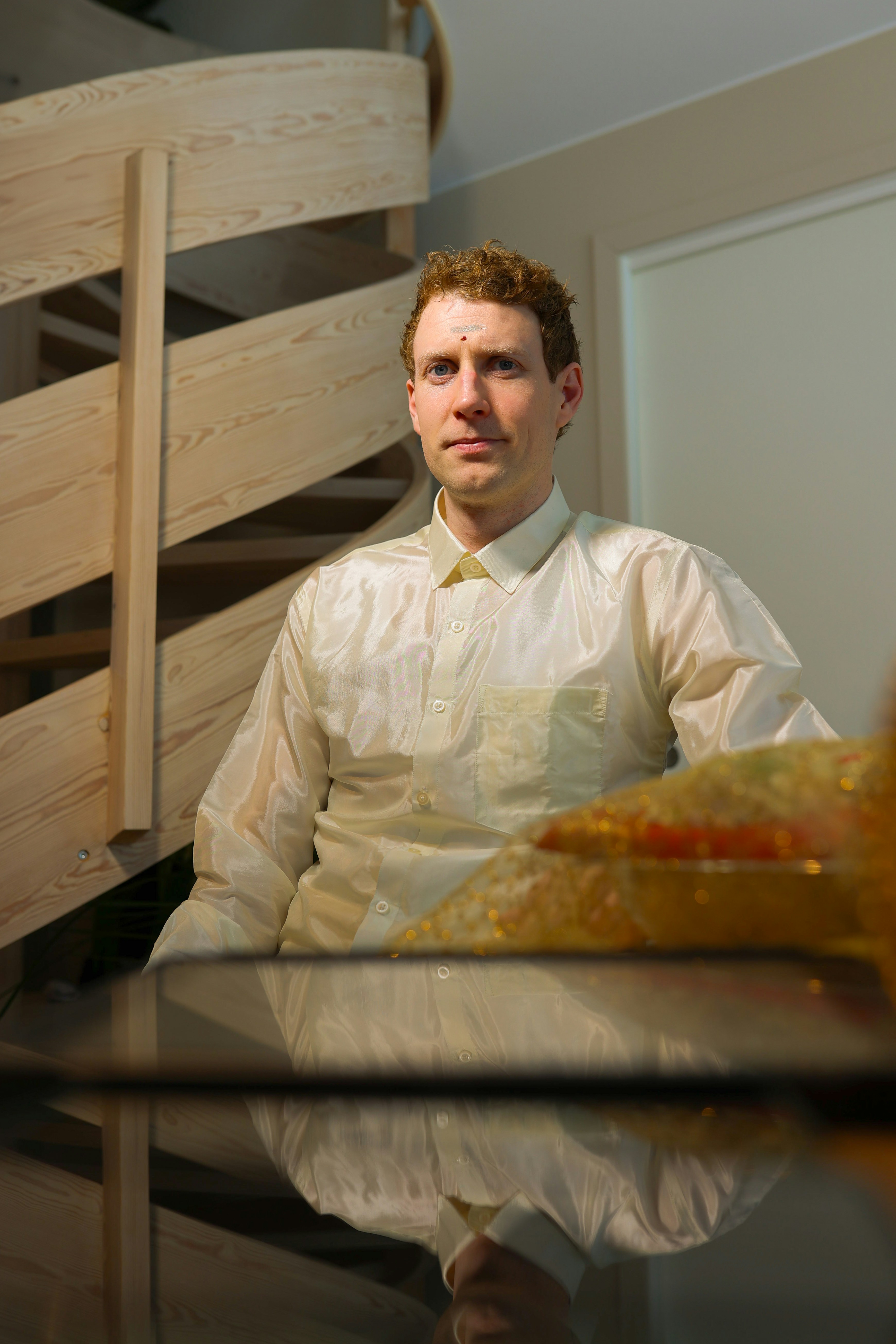 A man sitting at a table with food in front of him