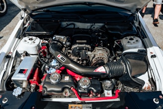 The engine of a car parked in a parking lot