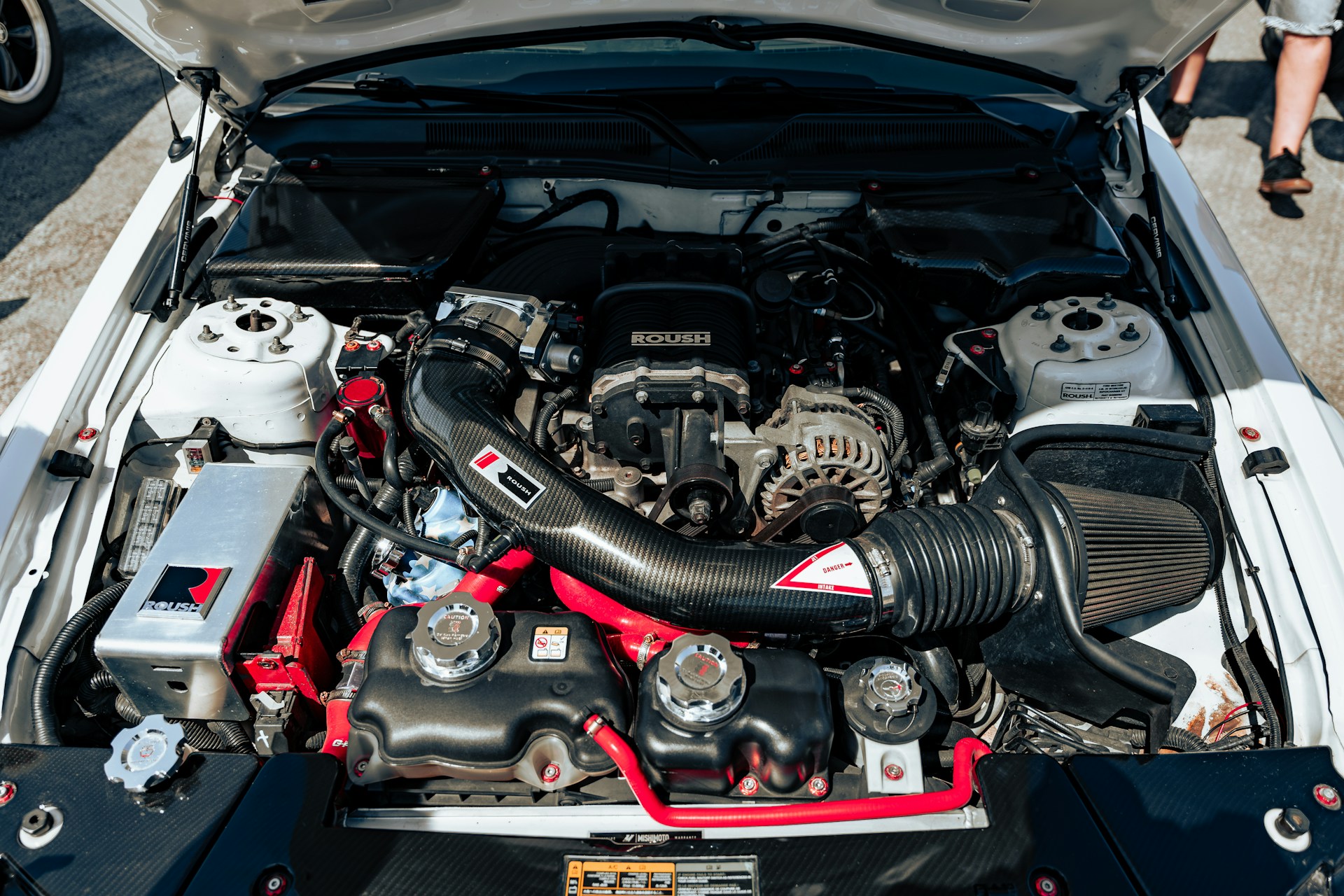 The engine of a car parked in a parking lot