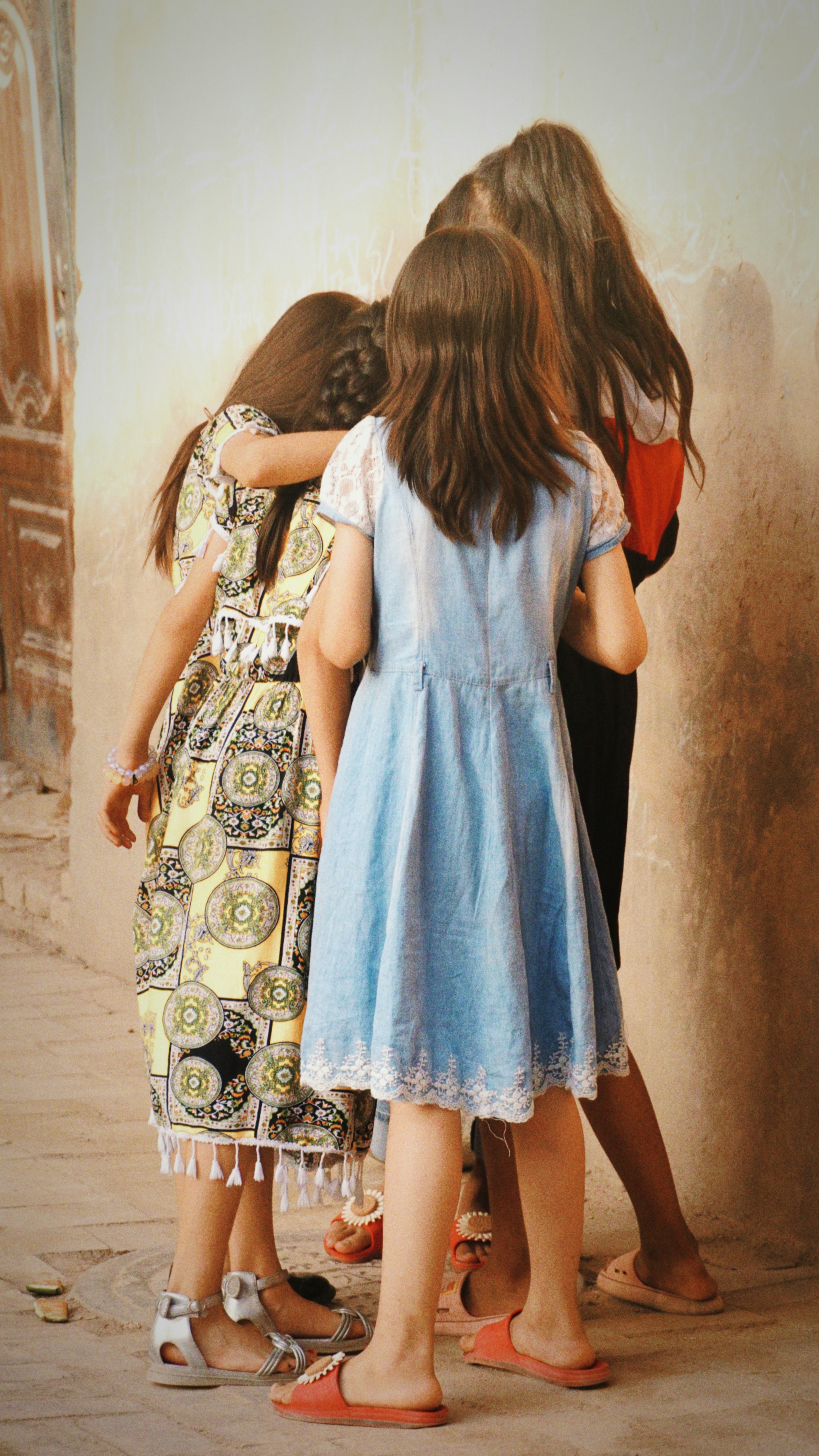 A group of young girls standing next to each other