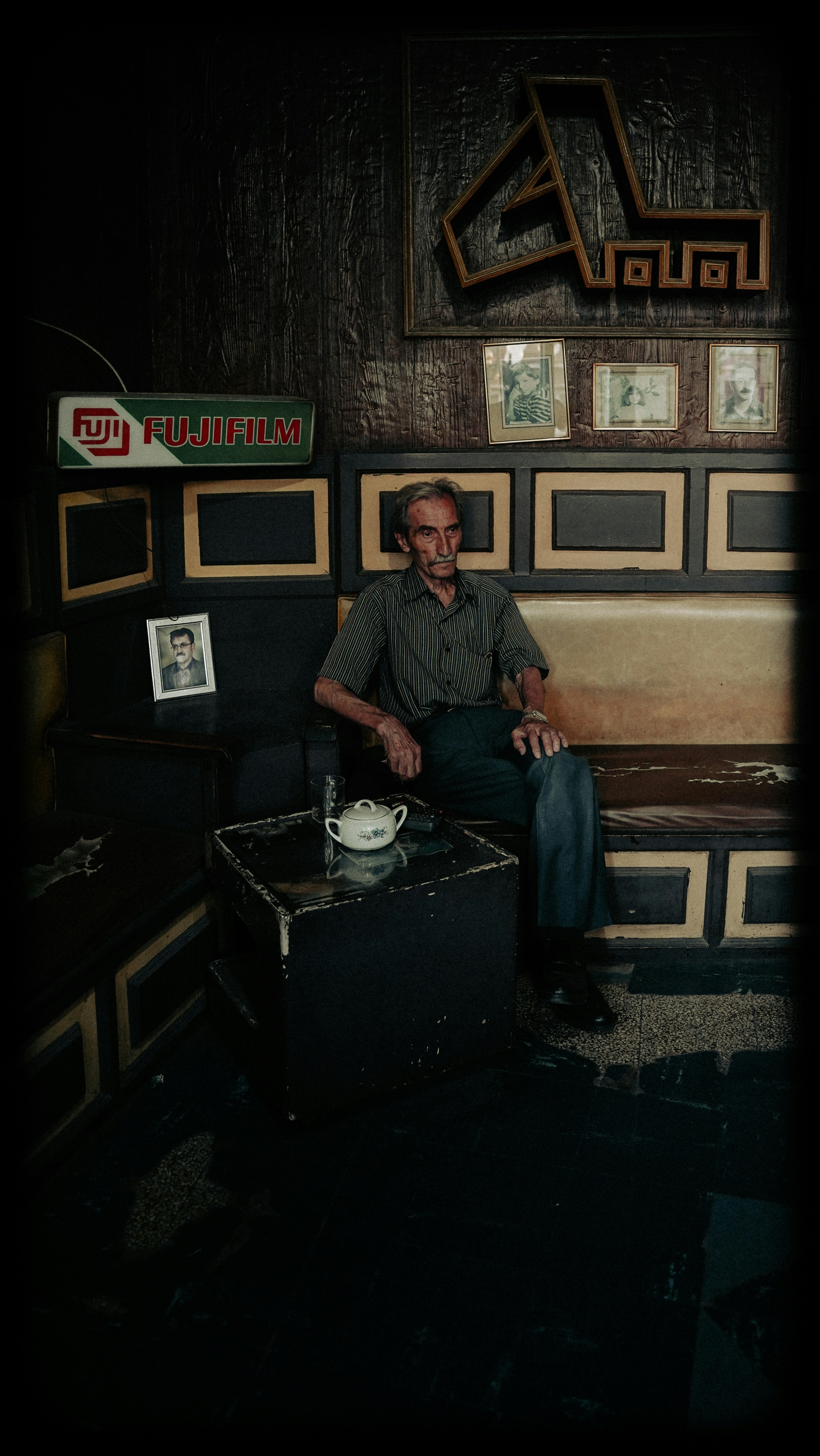 A man sitting on a bench in a room