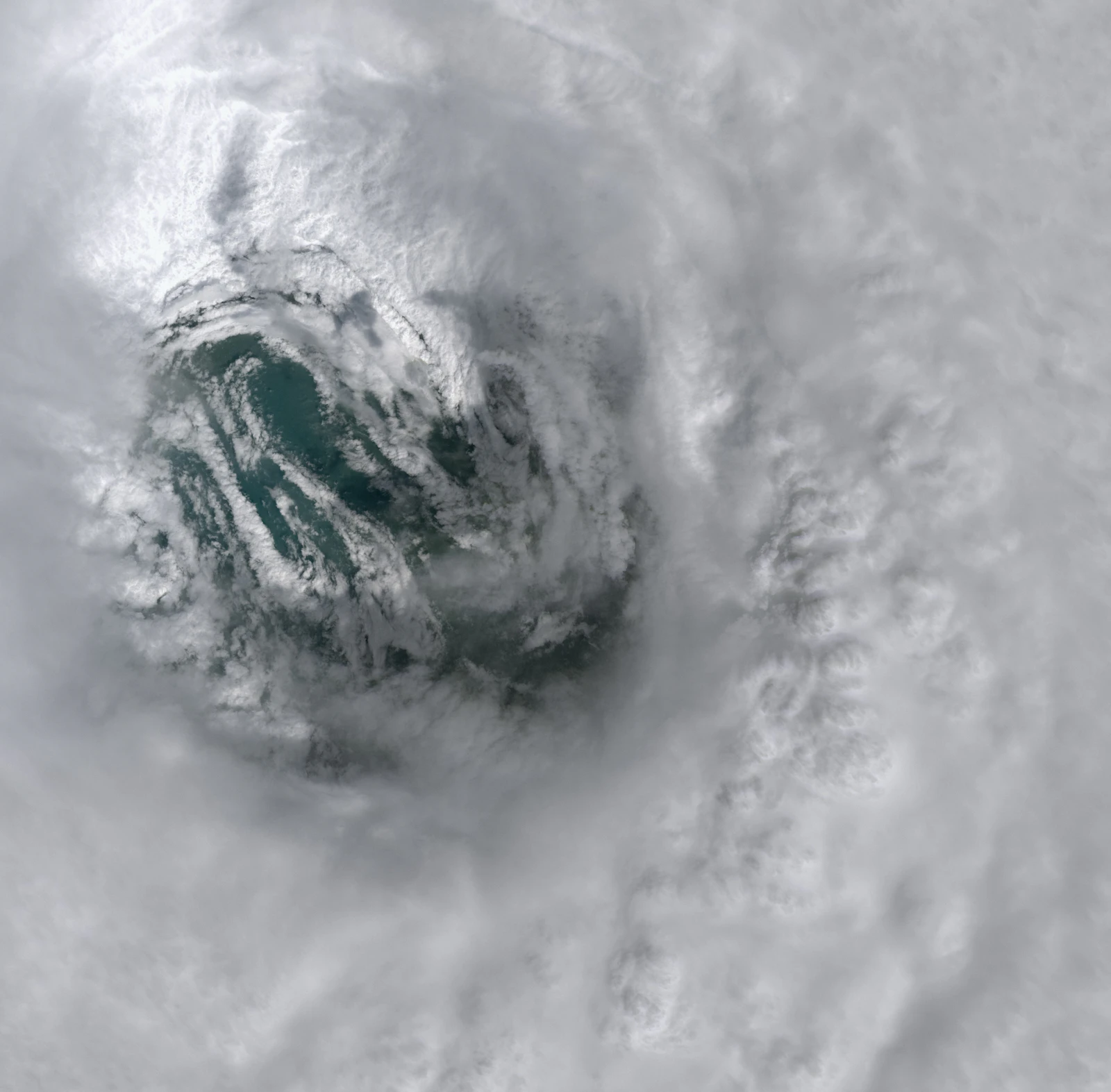 Satellite view looking straight down into the eye of a hurricane over open ocean, the kind of storm structure hurricane nowcasting models are built to track