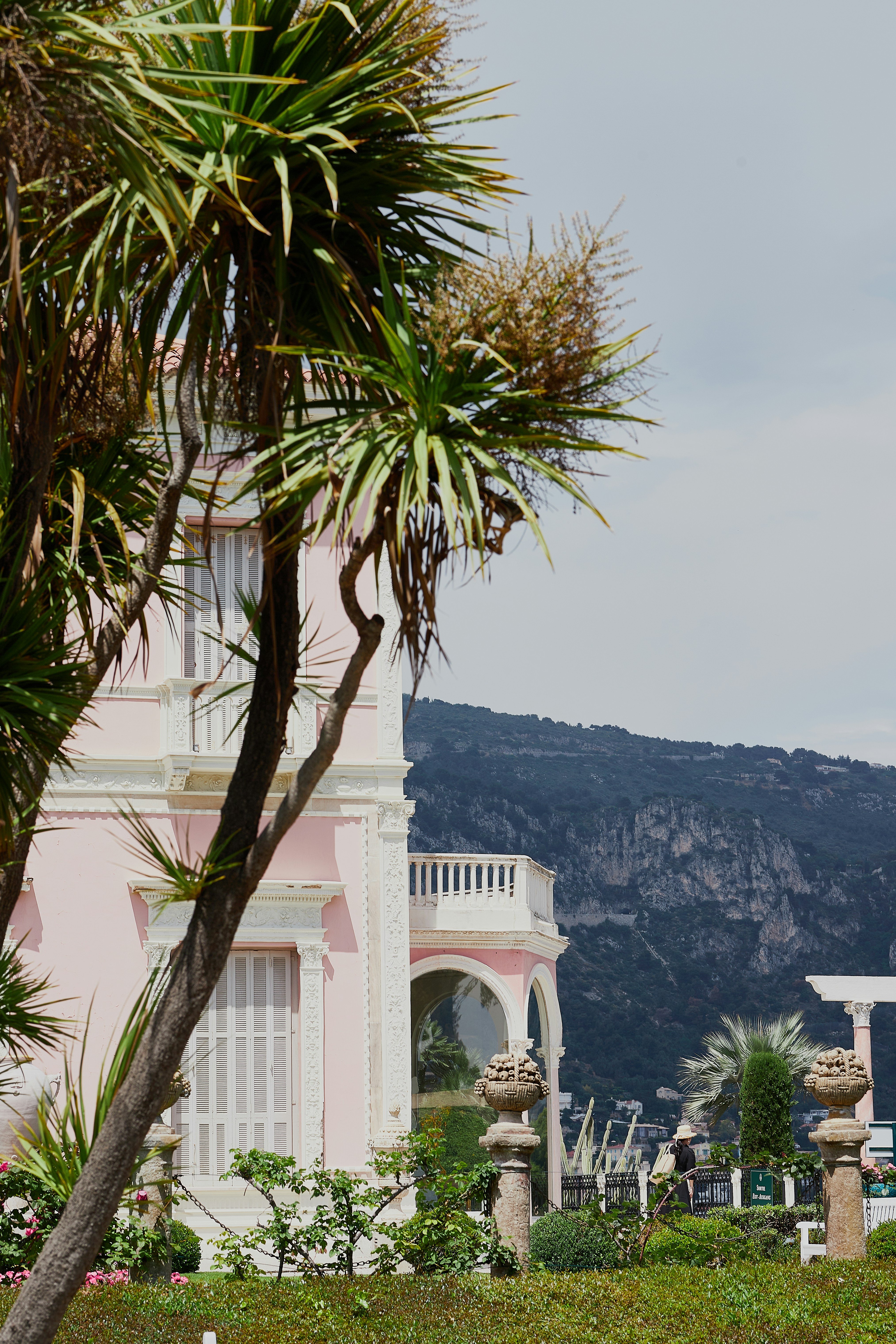 A pink building with a clock tower in the background