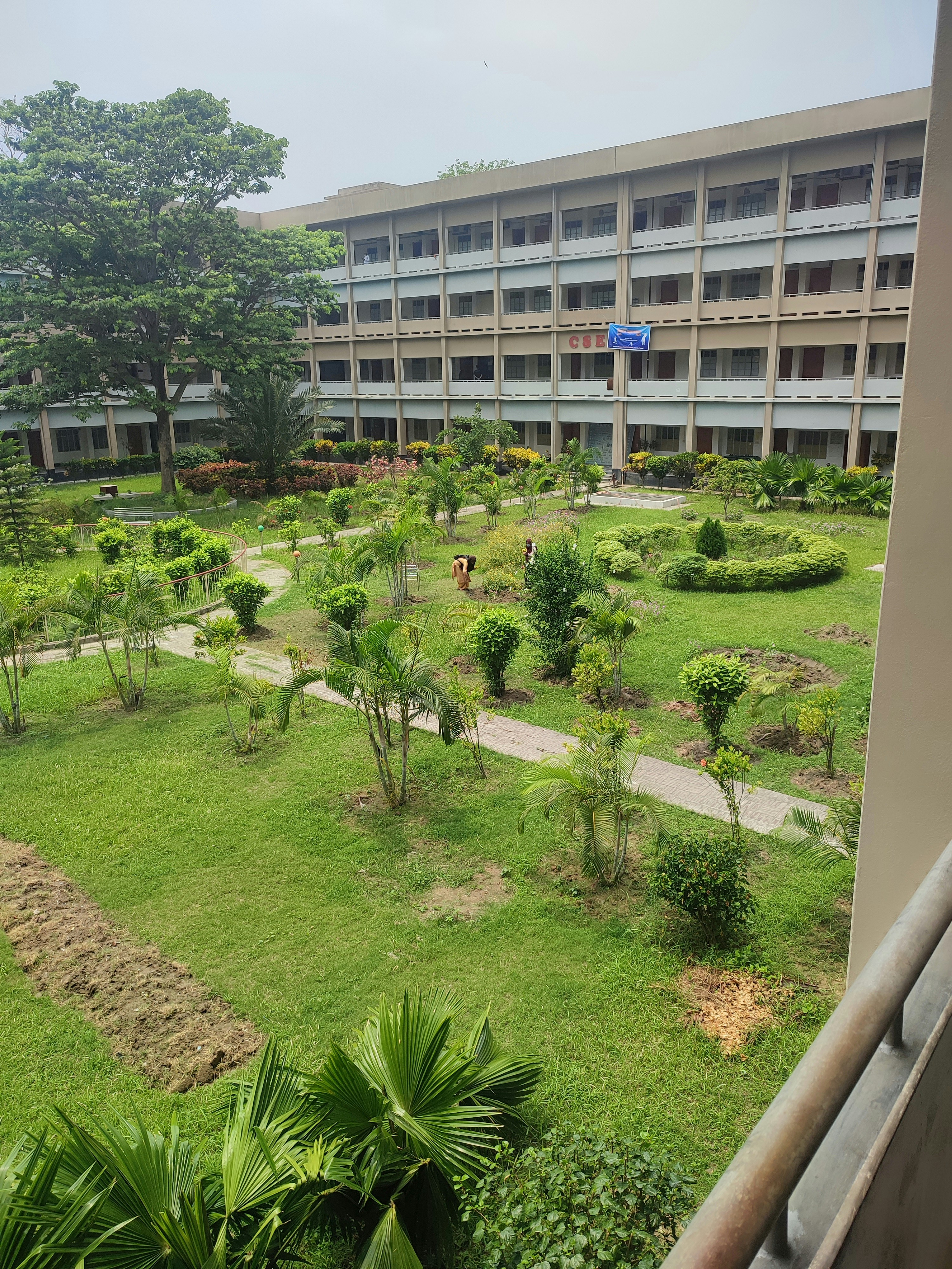 Satisfied client standing in front of a well-maintained garden, natural light