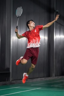 A man jumping in the air with a tennis racket