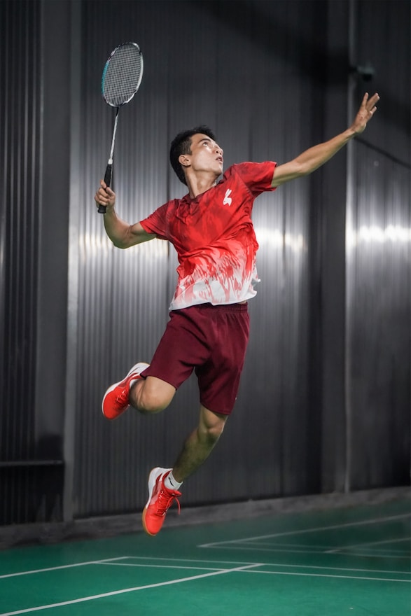 A man jumping in the air with a tennis racket