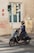 A man in a suit riding a scooter