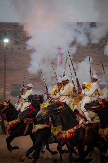 A group of men riding on the backs of horses