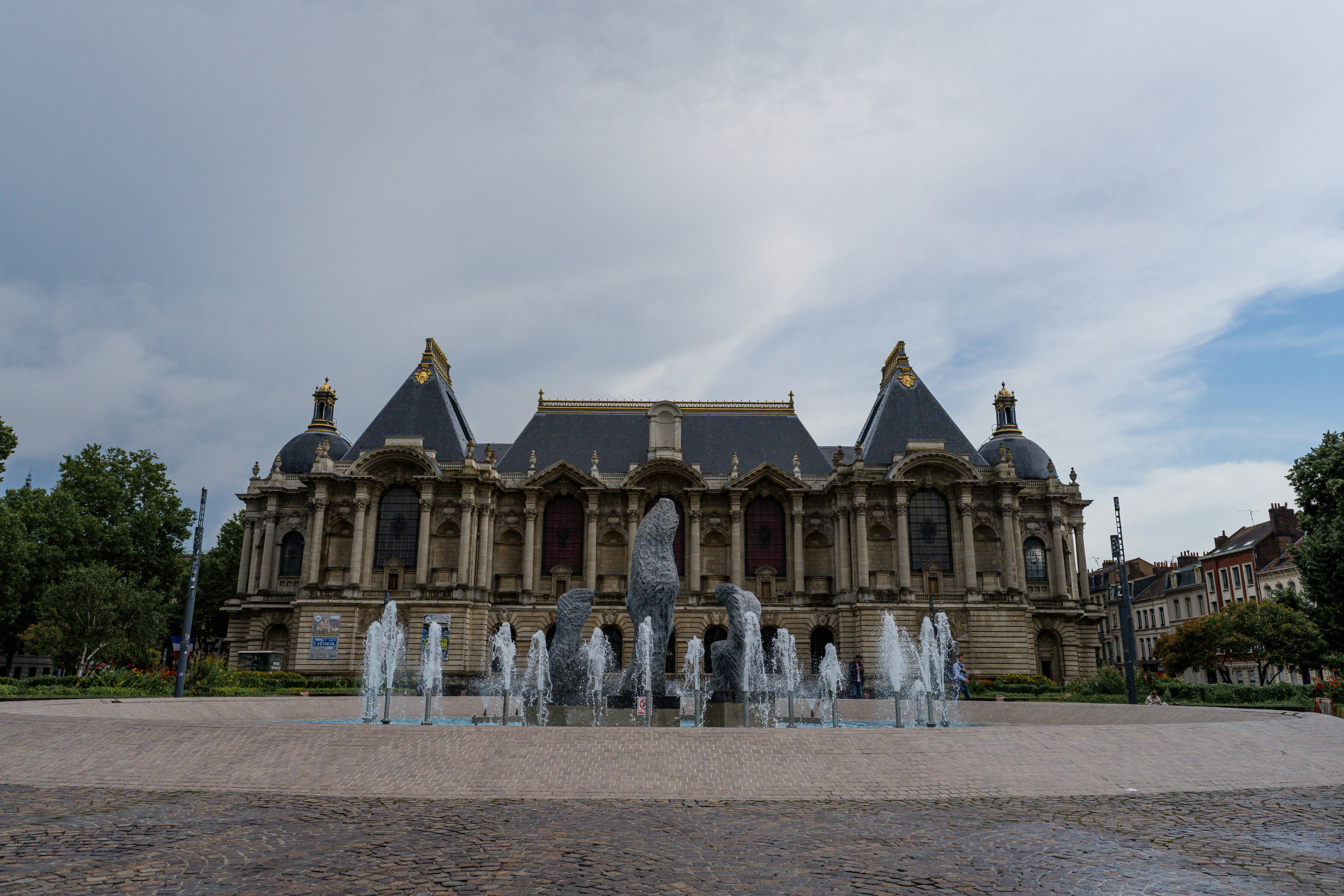 A large building with a fountain in front of it