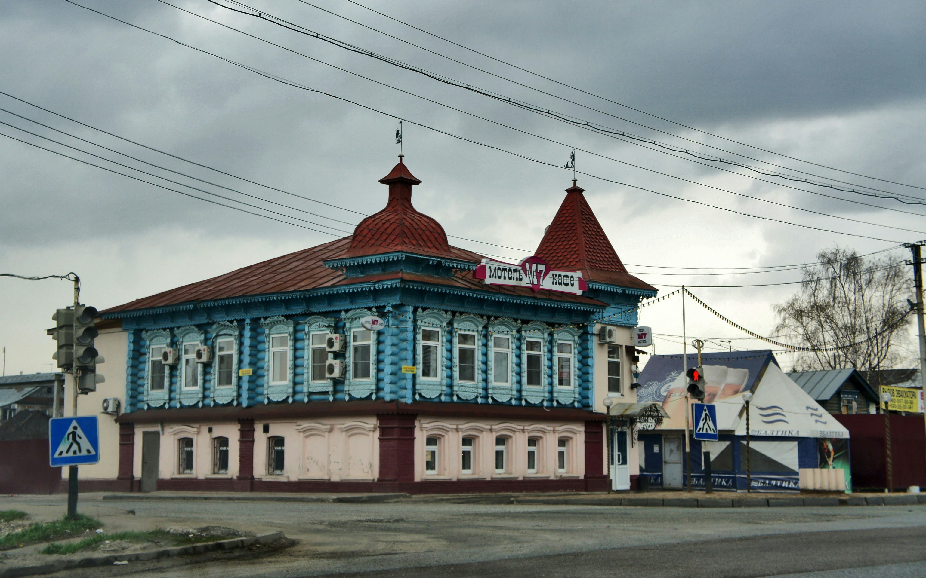 A blue and white building sitting on the side of a road