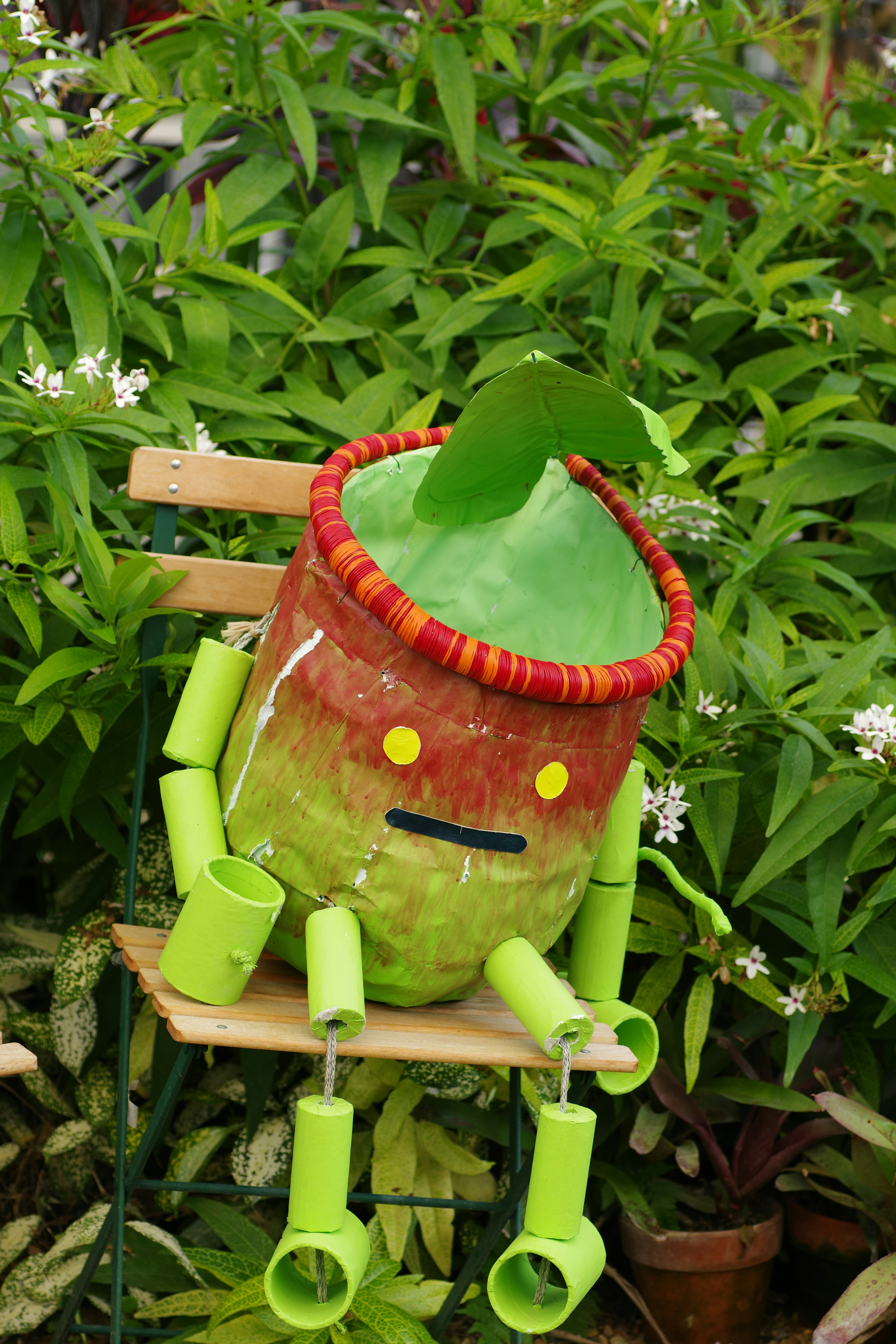 A potted plant sitting on top of a wooden chair