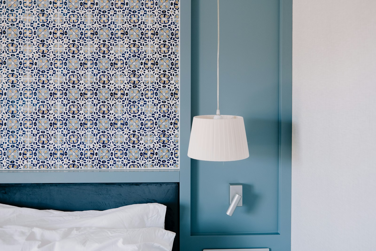 peel and stick tile pattern wallpaper accent above bed