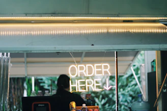 A man sitting at a table in front of a store window