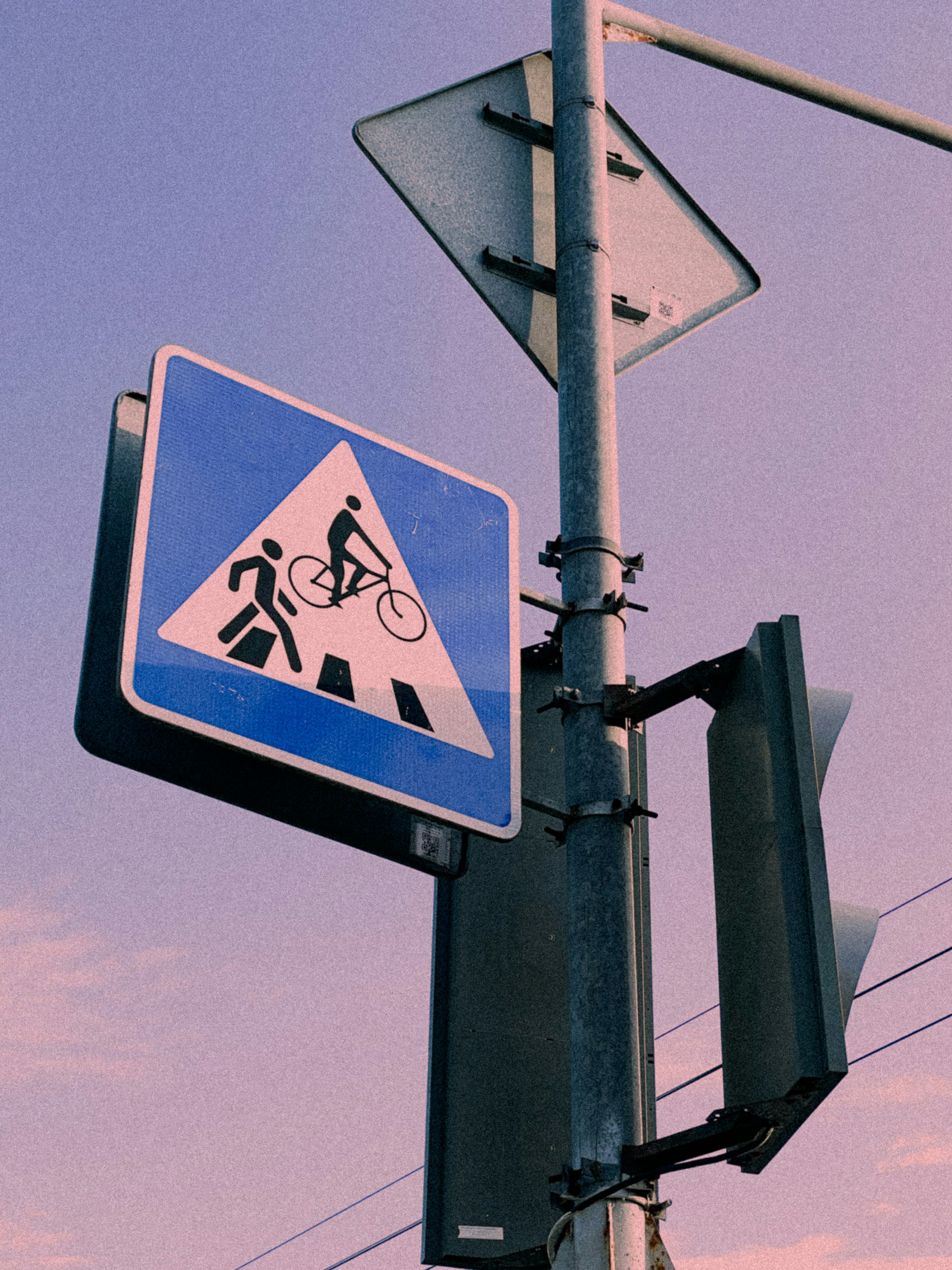 A street sign on a pole with a sky background