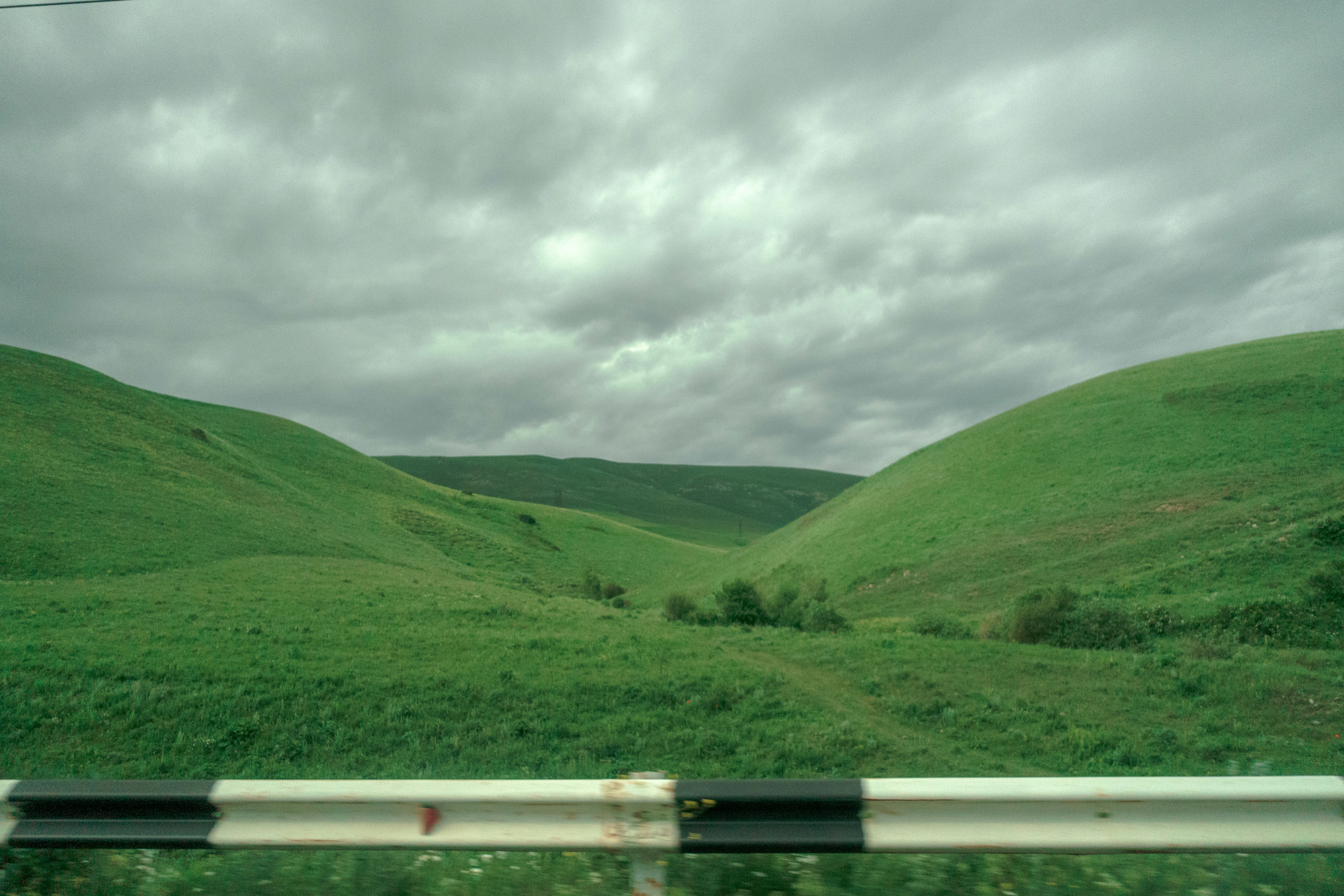A view of a field with hills in the distance
