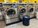 A row of washing machines in a laundry room