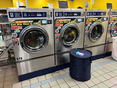 A row of washing machines in a laundry room