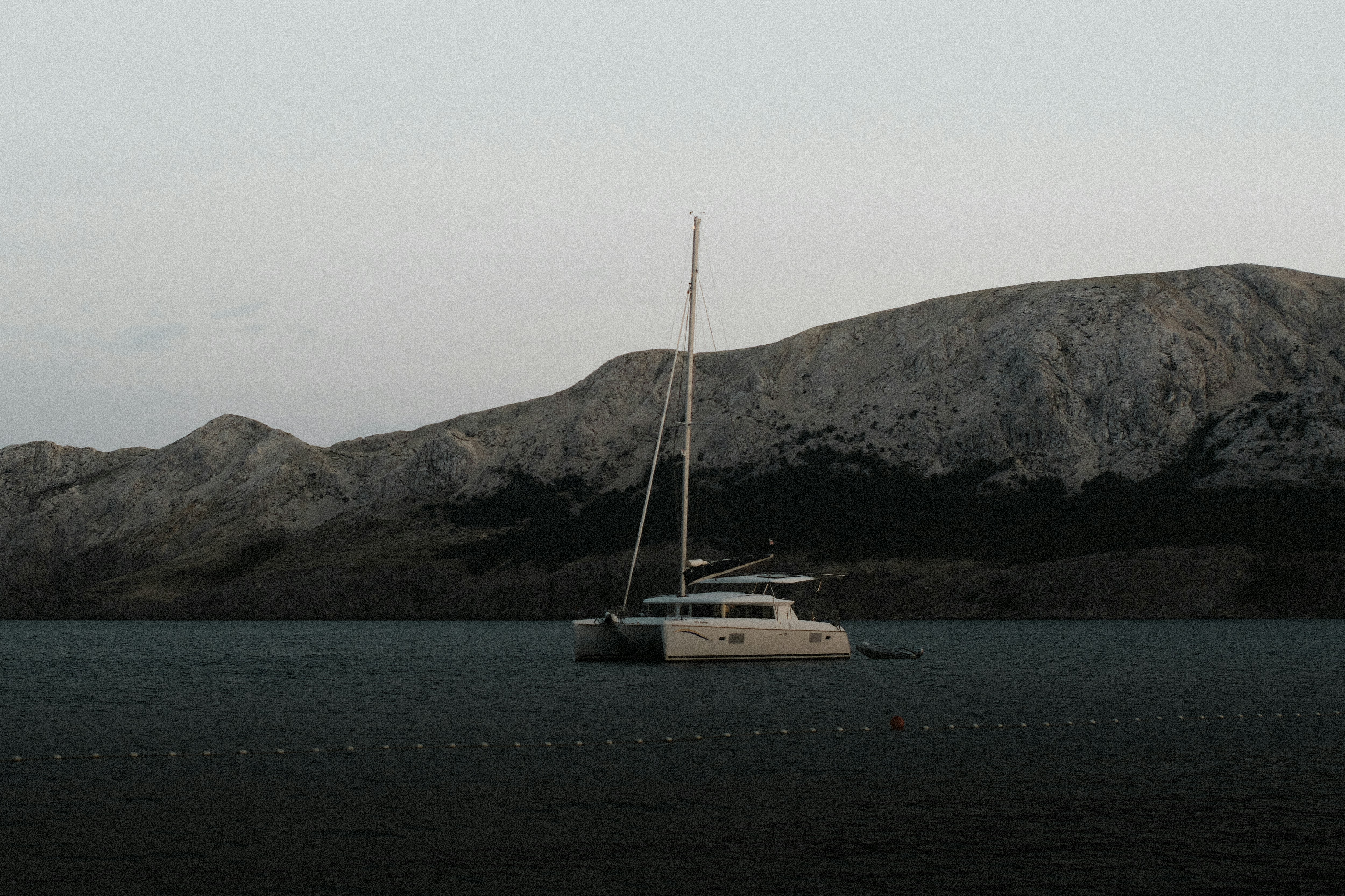 A boat floating on top of a large body of water, 