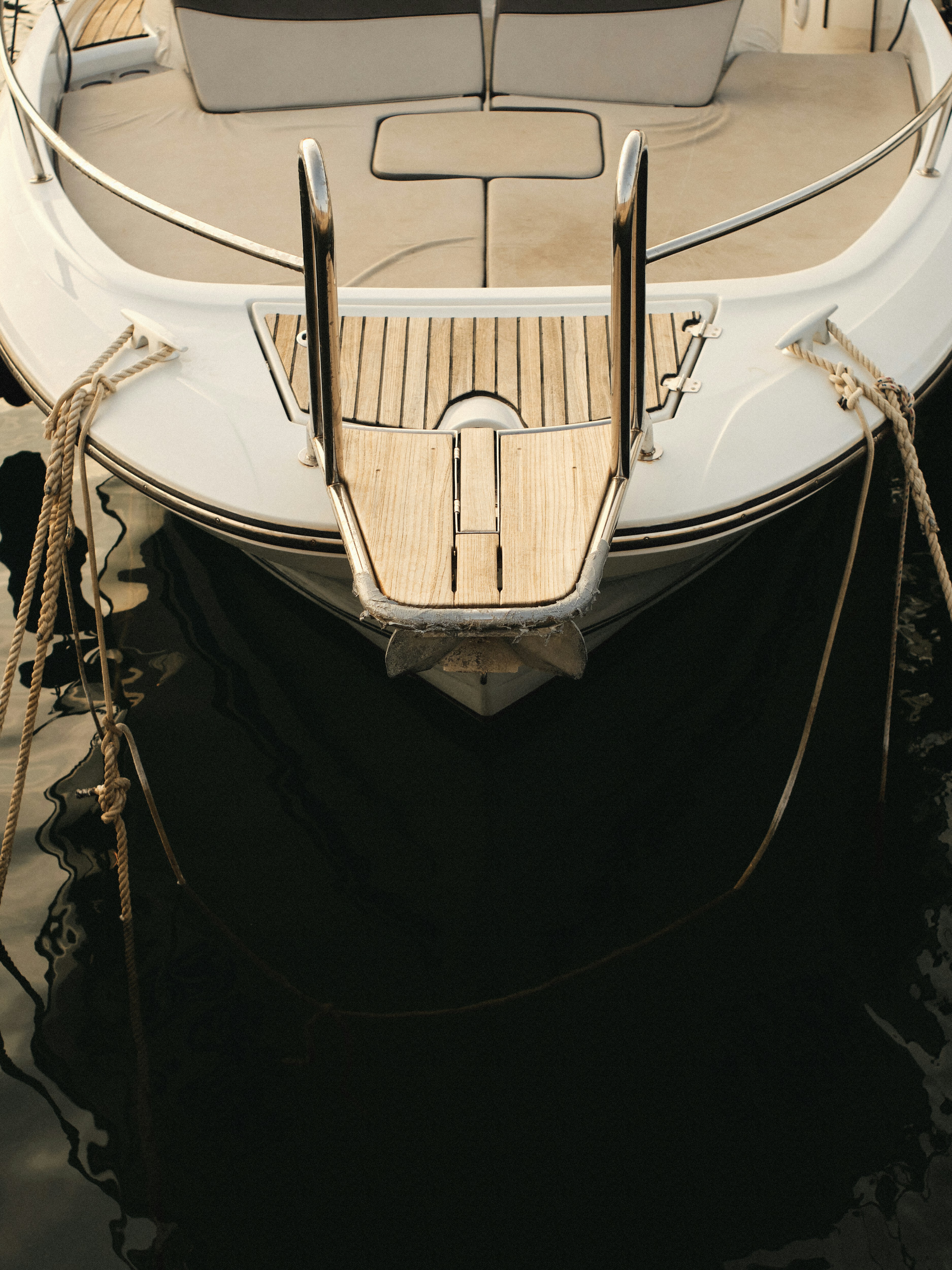 A white boat is docked in the water