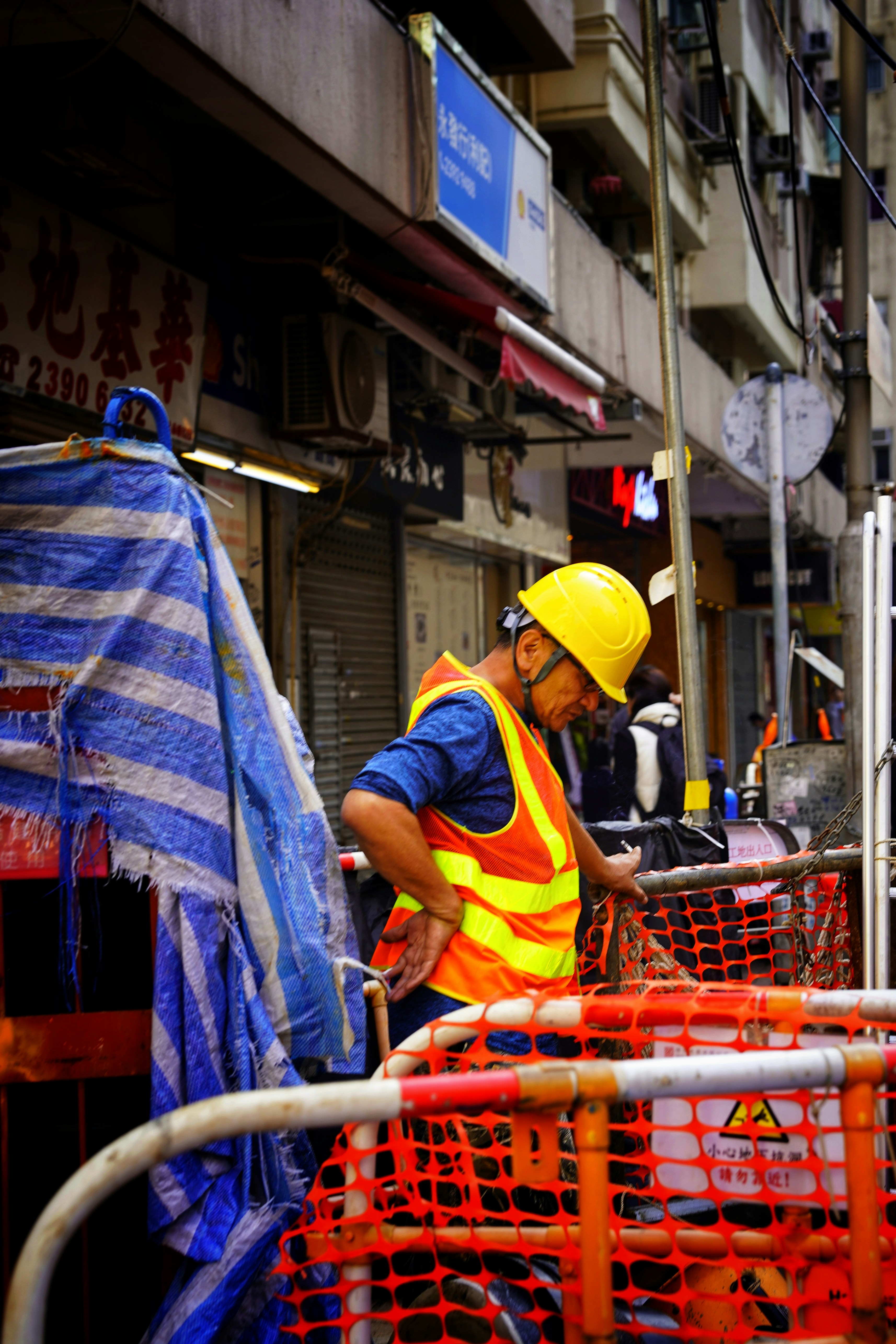 A man in a yellow safety vest working on a construction site