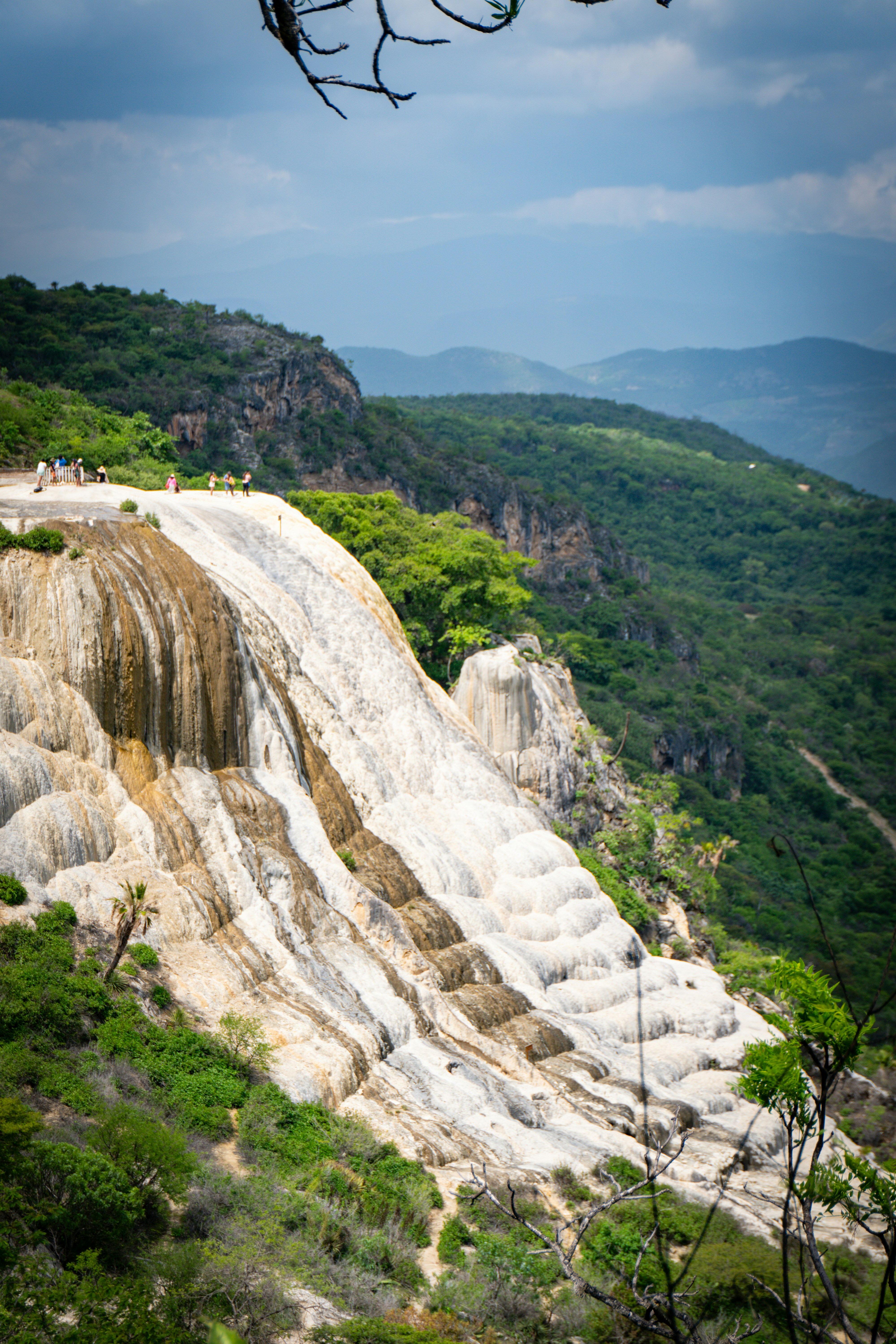 A scenic view of a waterfall in the mountains