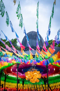 Many colorful flags are flying in the air