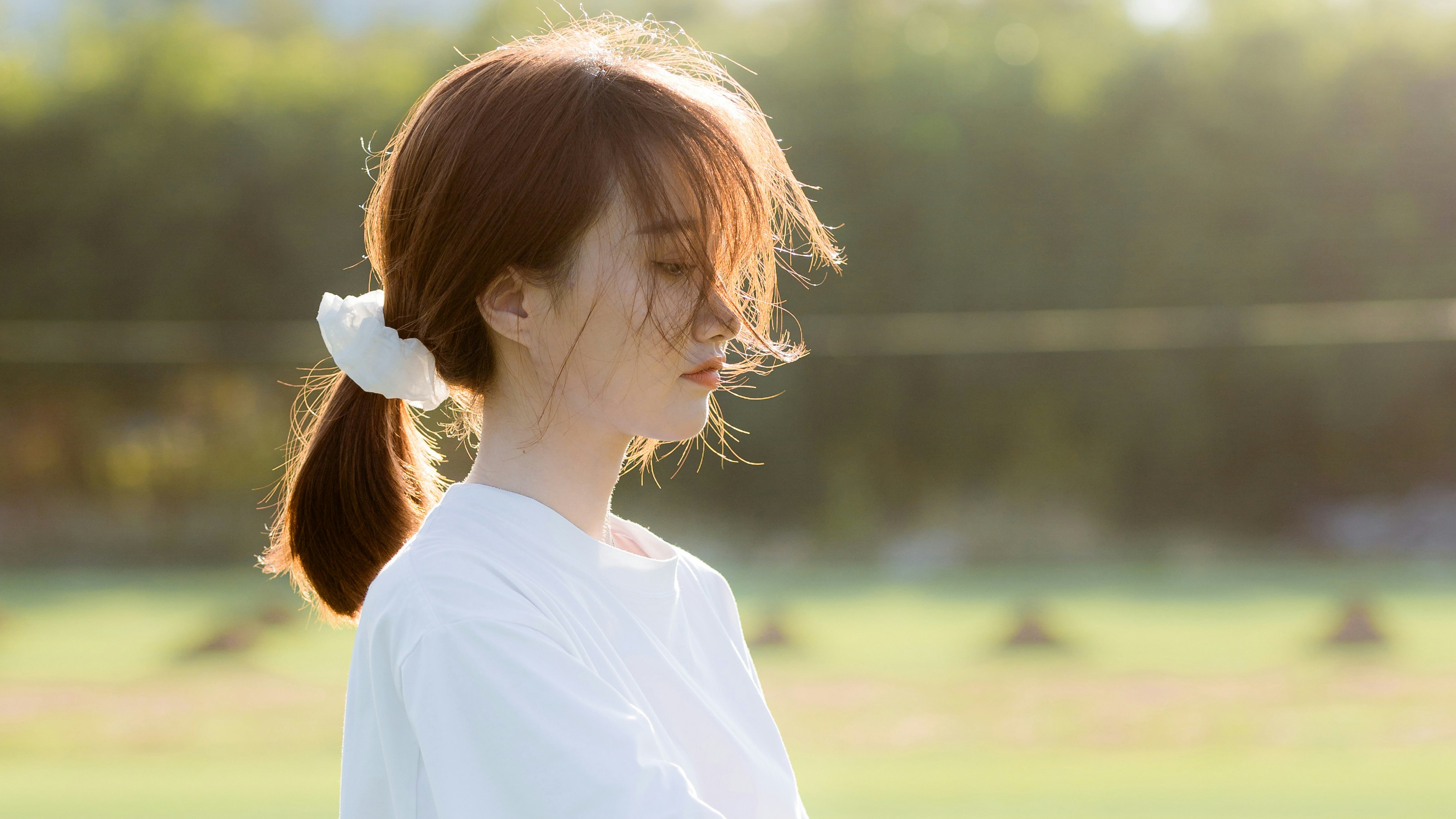 A woman standing on a field with a frisbee in her hand