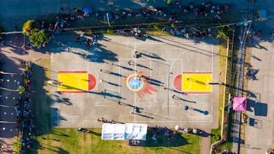 An aerial view of a basketball court in a parking lot