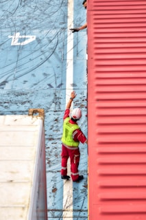 A man standing on top of a red roof