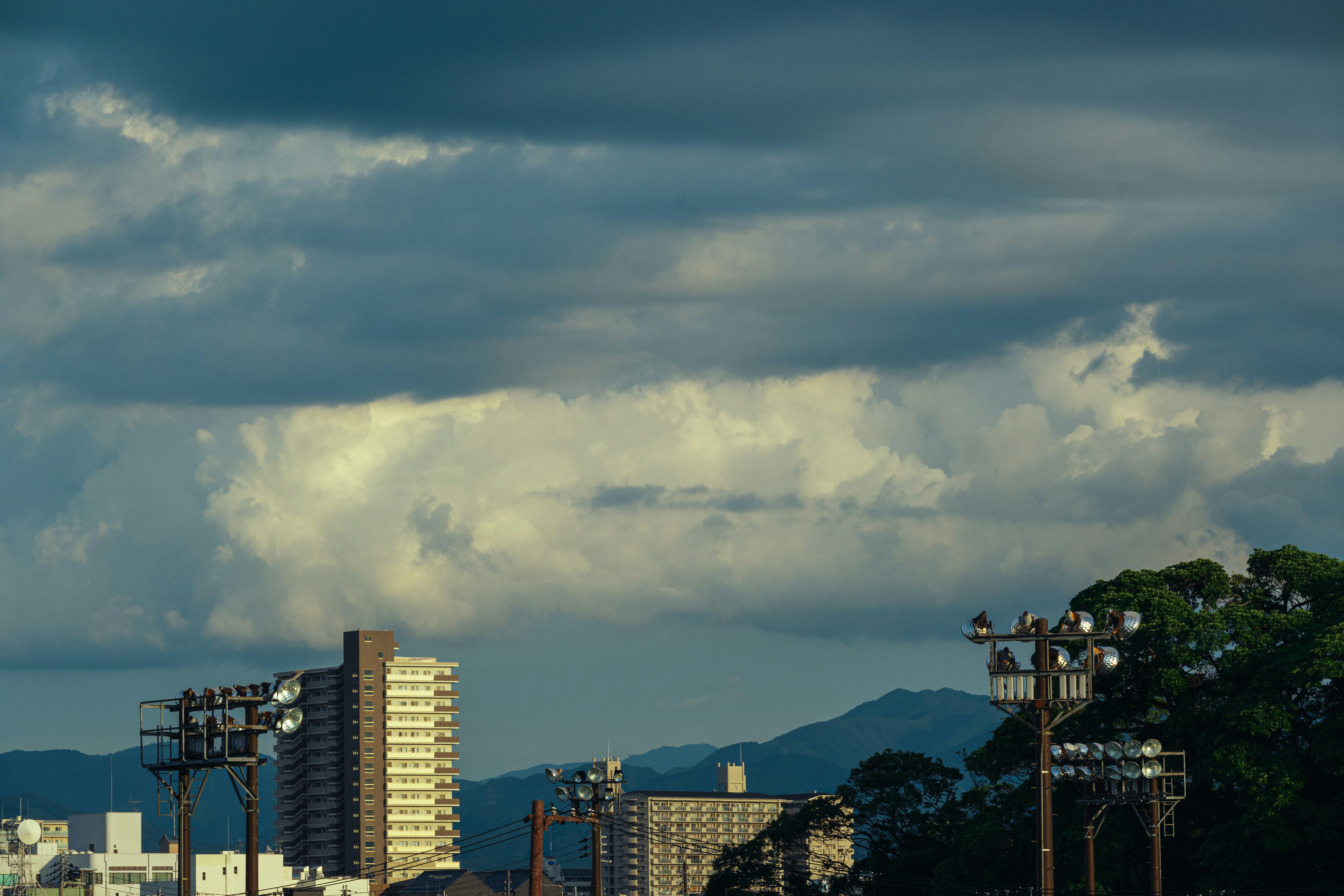 A view of a city with tall buildings under a cloudy sky photo – Free ...