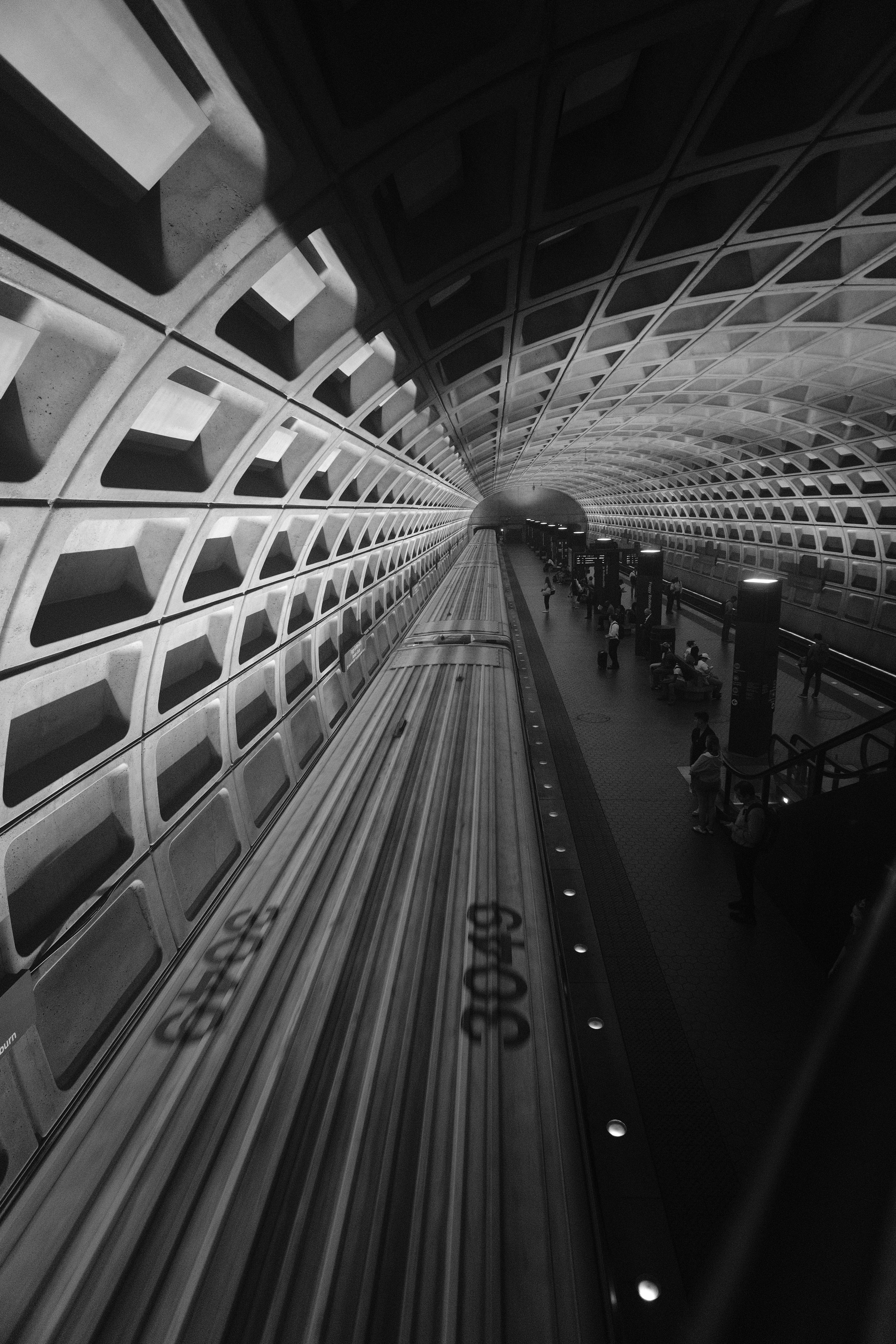 A black and white photo of a subway station