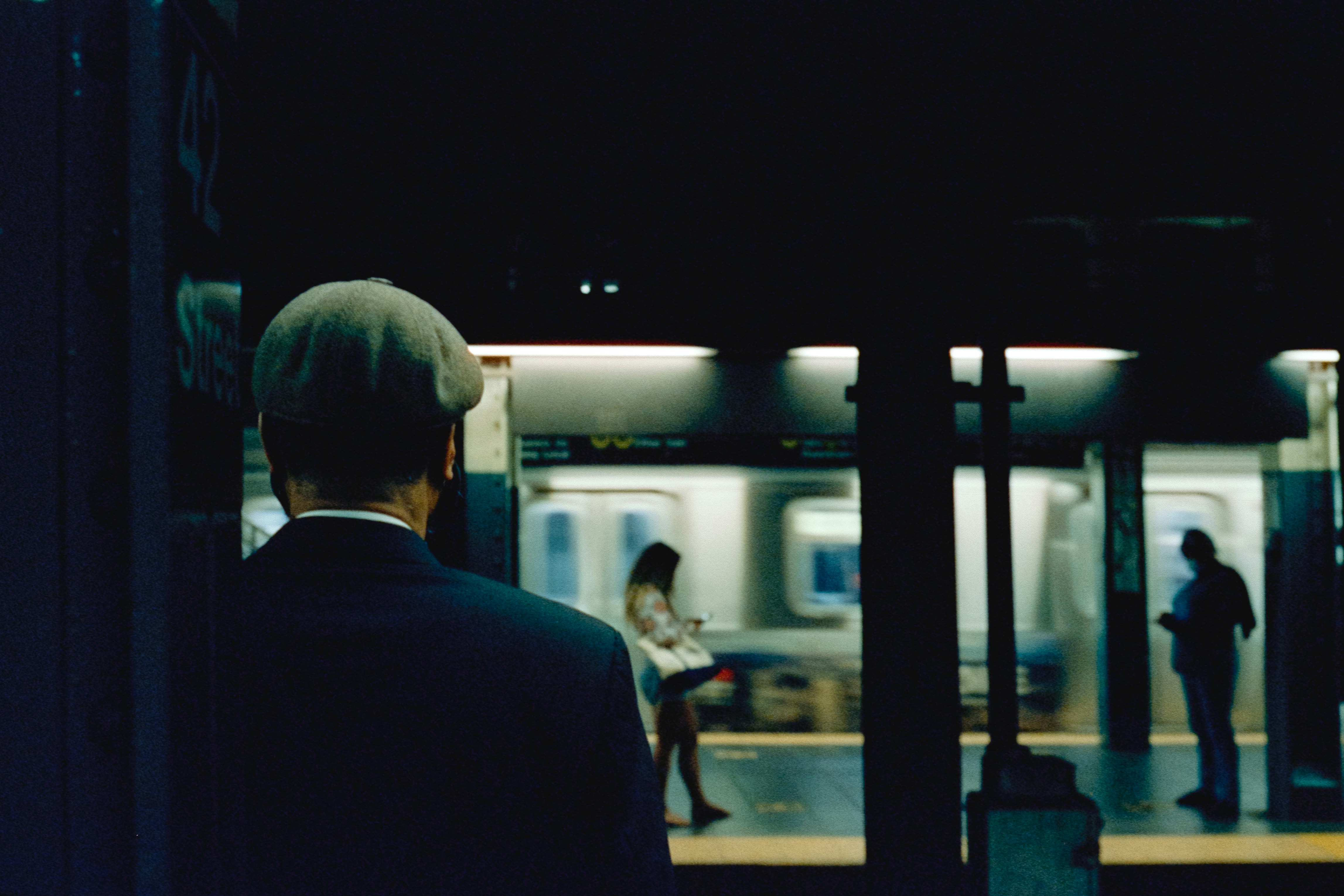 A man in a suit waiting for a train
