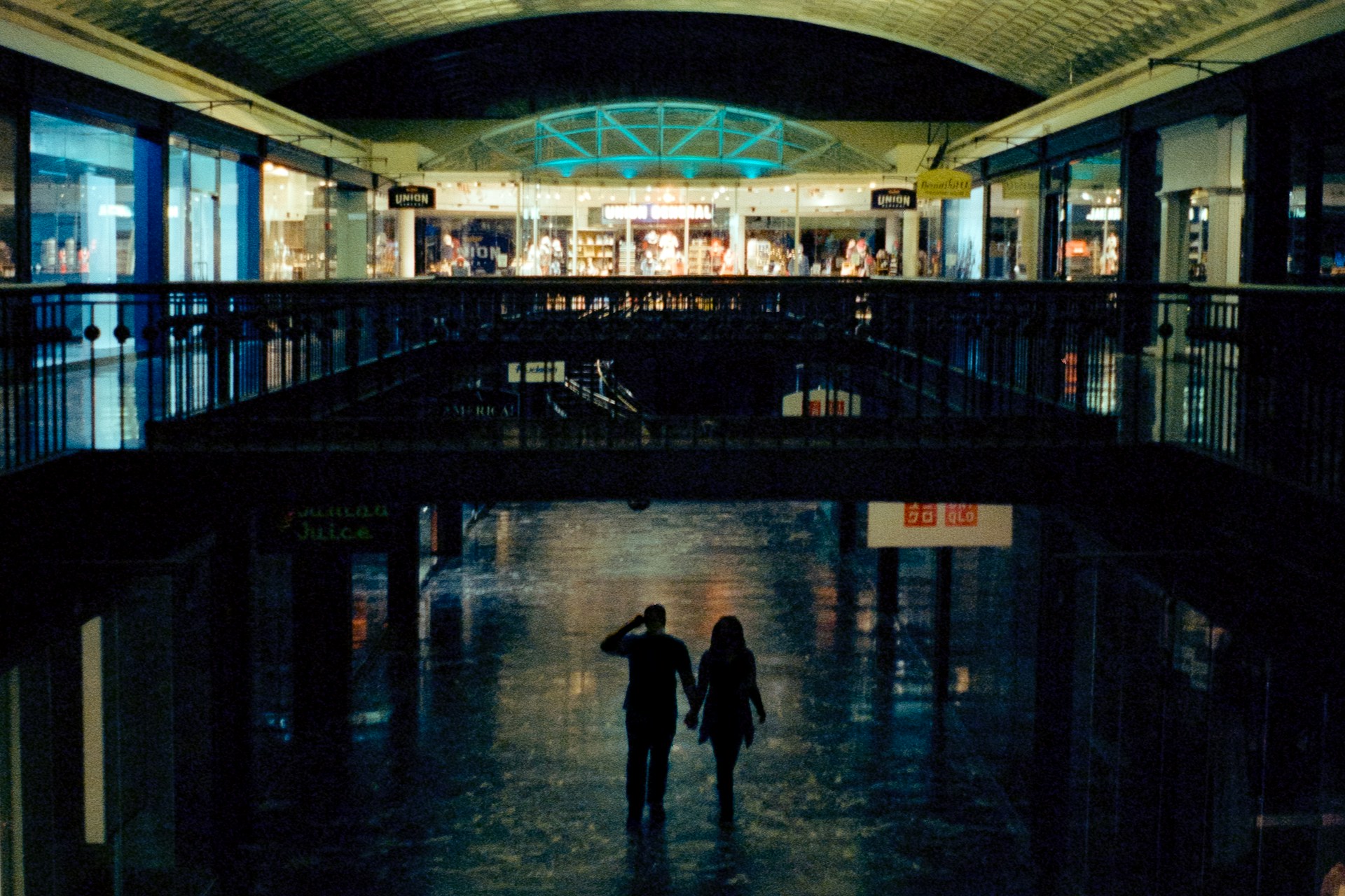 A couple of people walking through a building