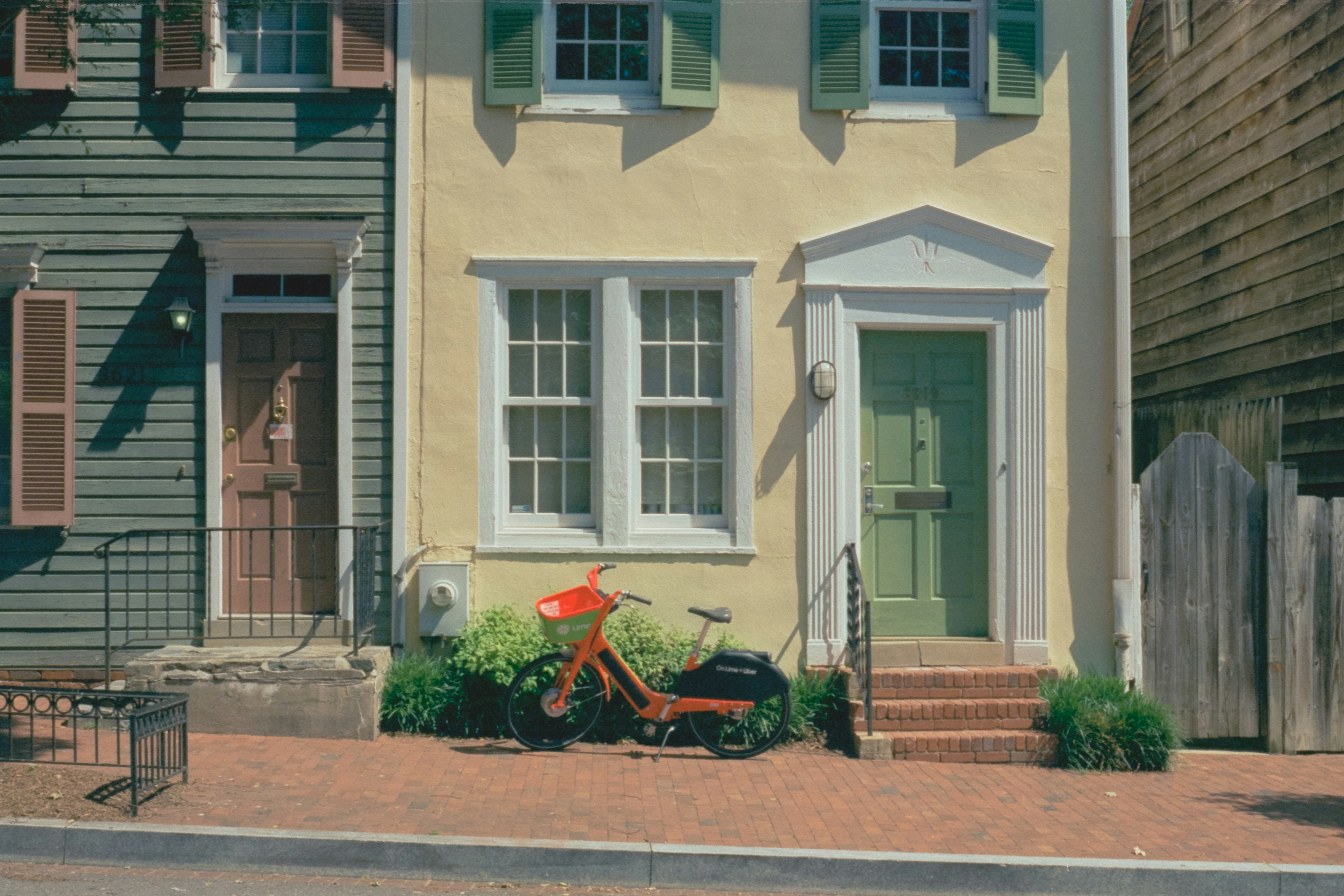A painting of a bike parked in front of a house