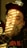 A man with glasses and a hat covering his face