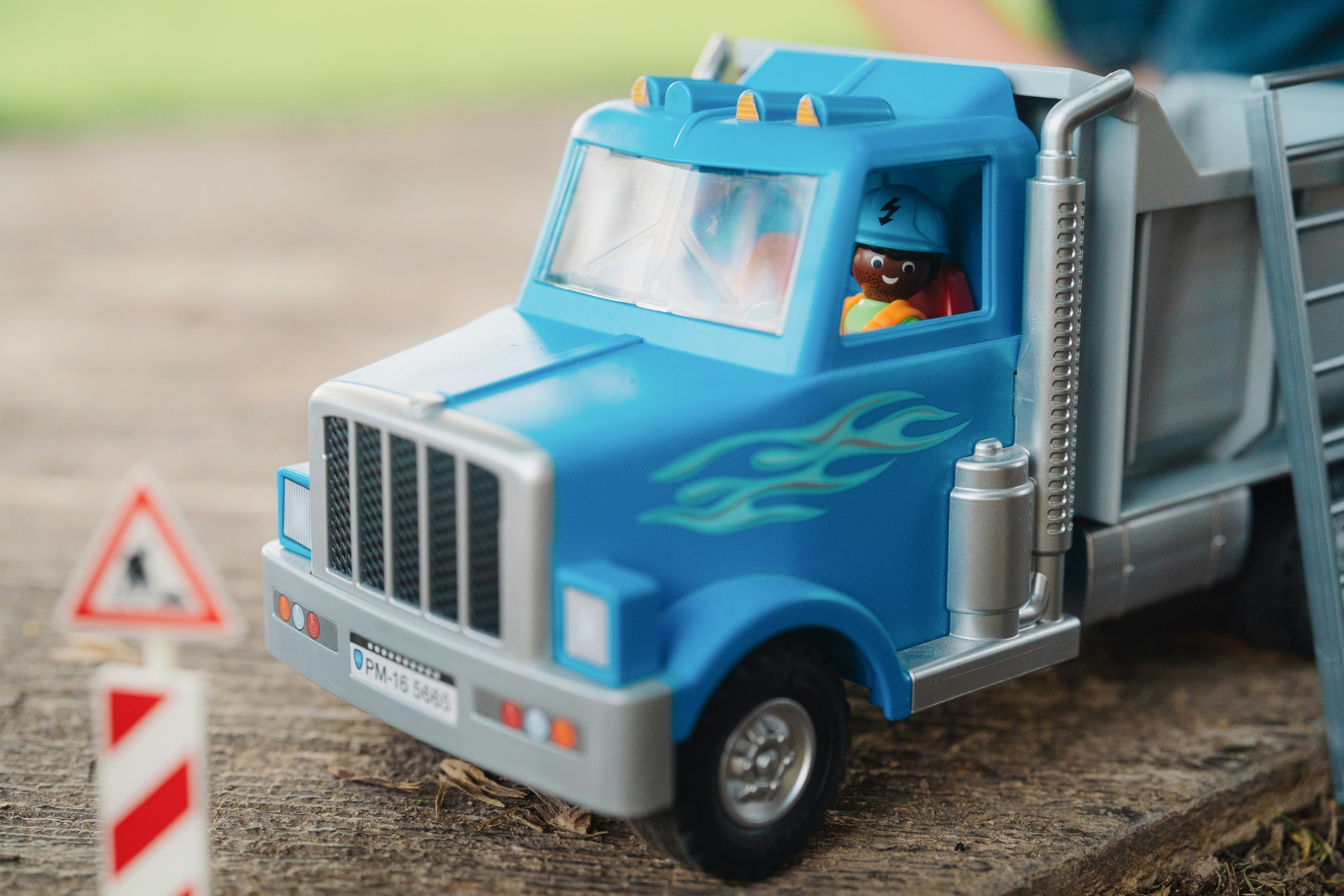 A toy truck with a man standing next to it