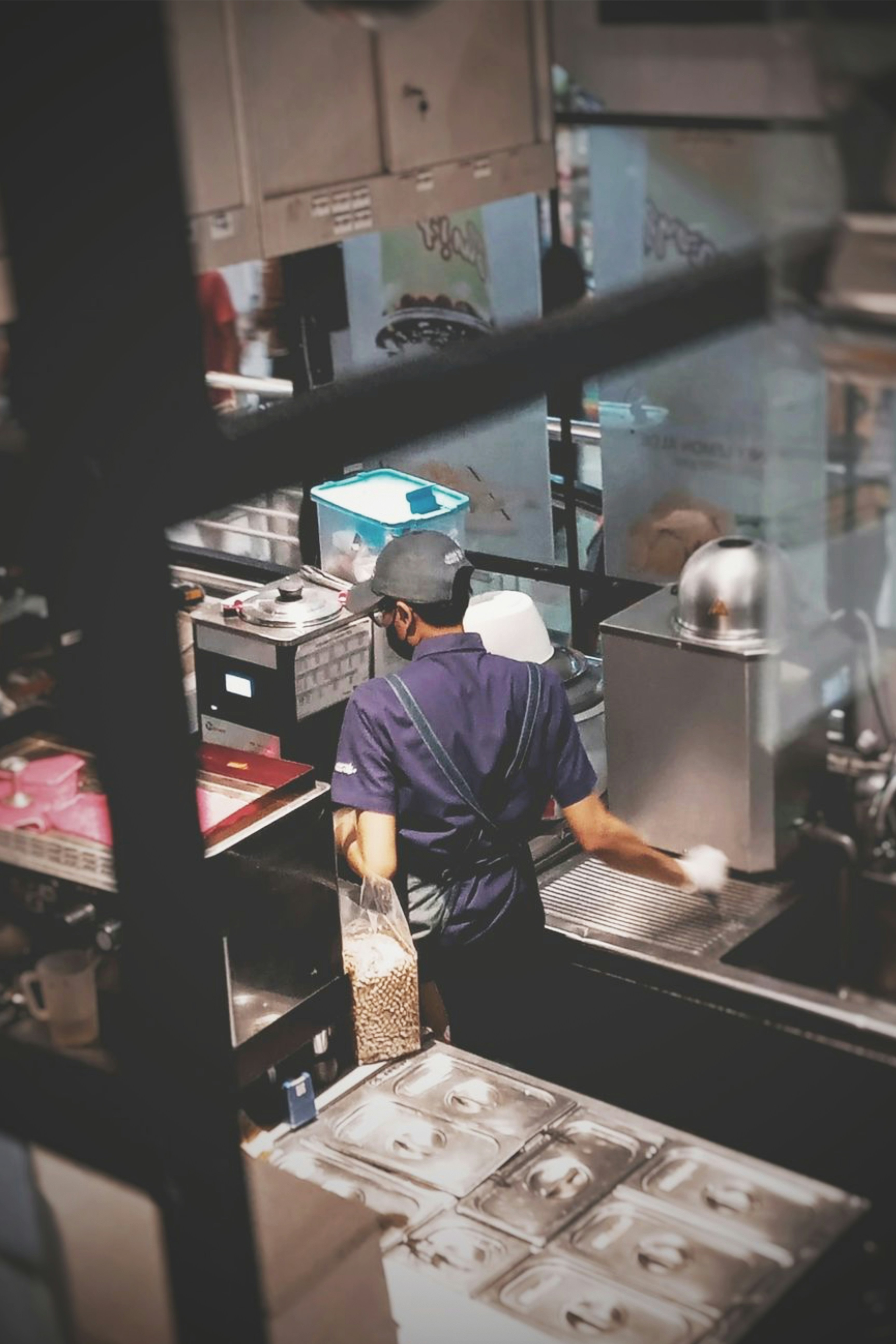 A man working in a commercial kitchen preparing food
