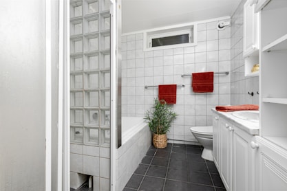 A bathroom with a toilet, sink, and bathtub