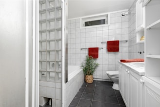 A bathroom with a toilet, sink, and bathtub