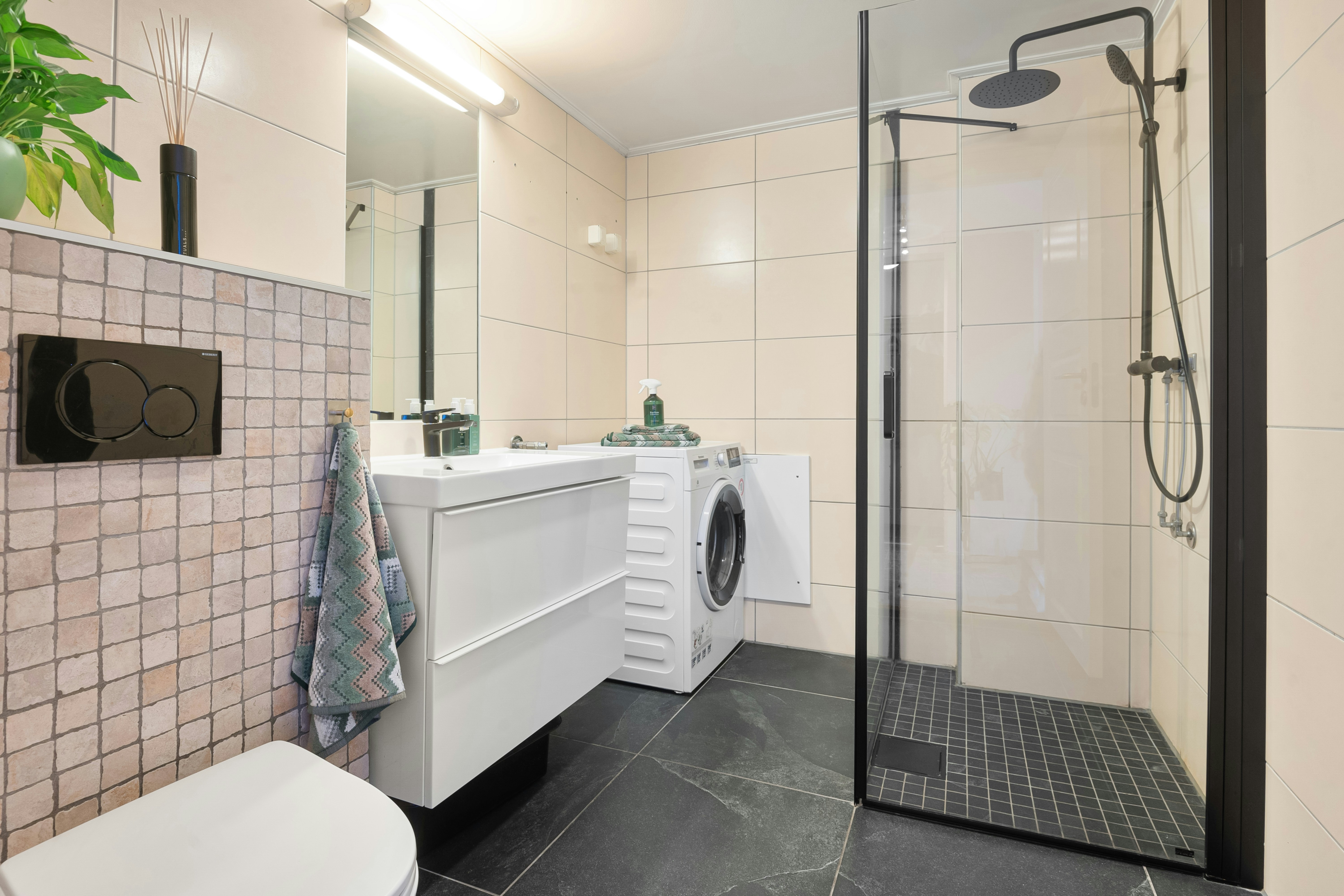 A bathroom with a toilet, sink, and shower
