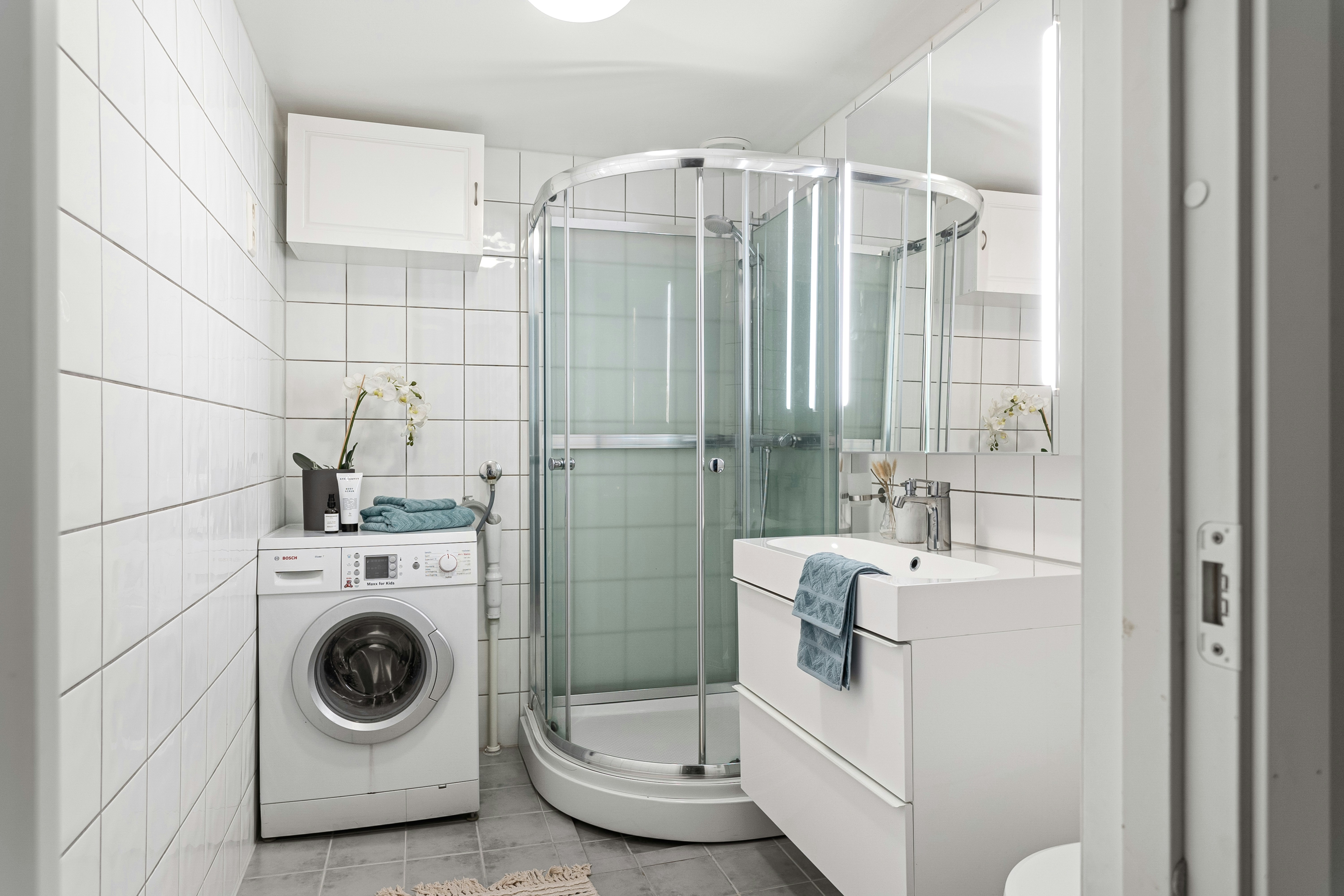 A washer and dryer in a small bathroom