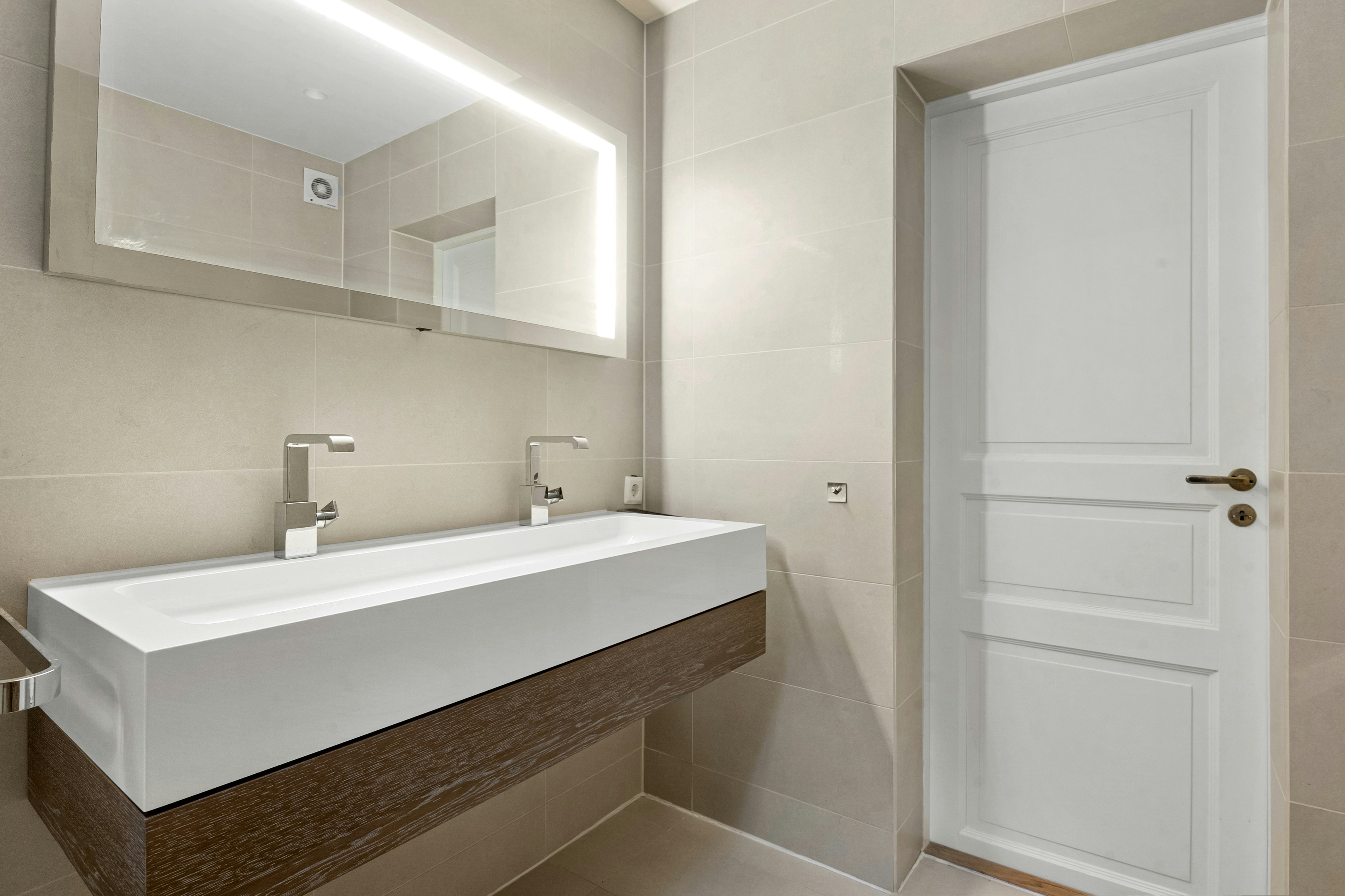 completed high-end bathroom with modern fixtures and natural light - high end bathroom remodel