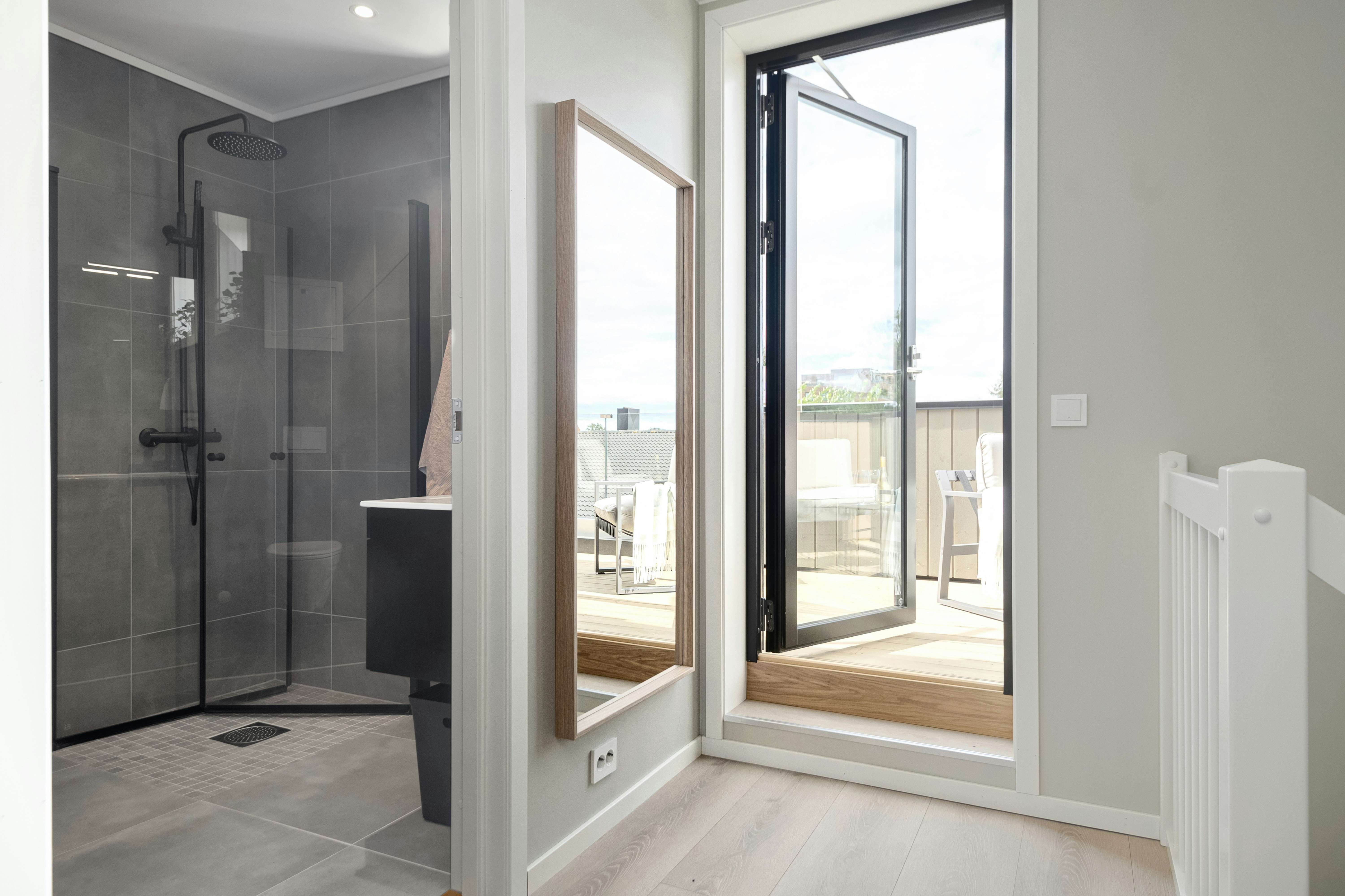 A bathroom with a walk in shower next to a toilet