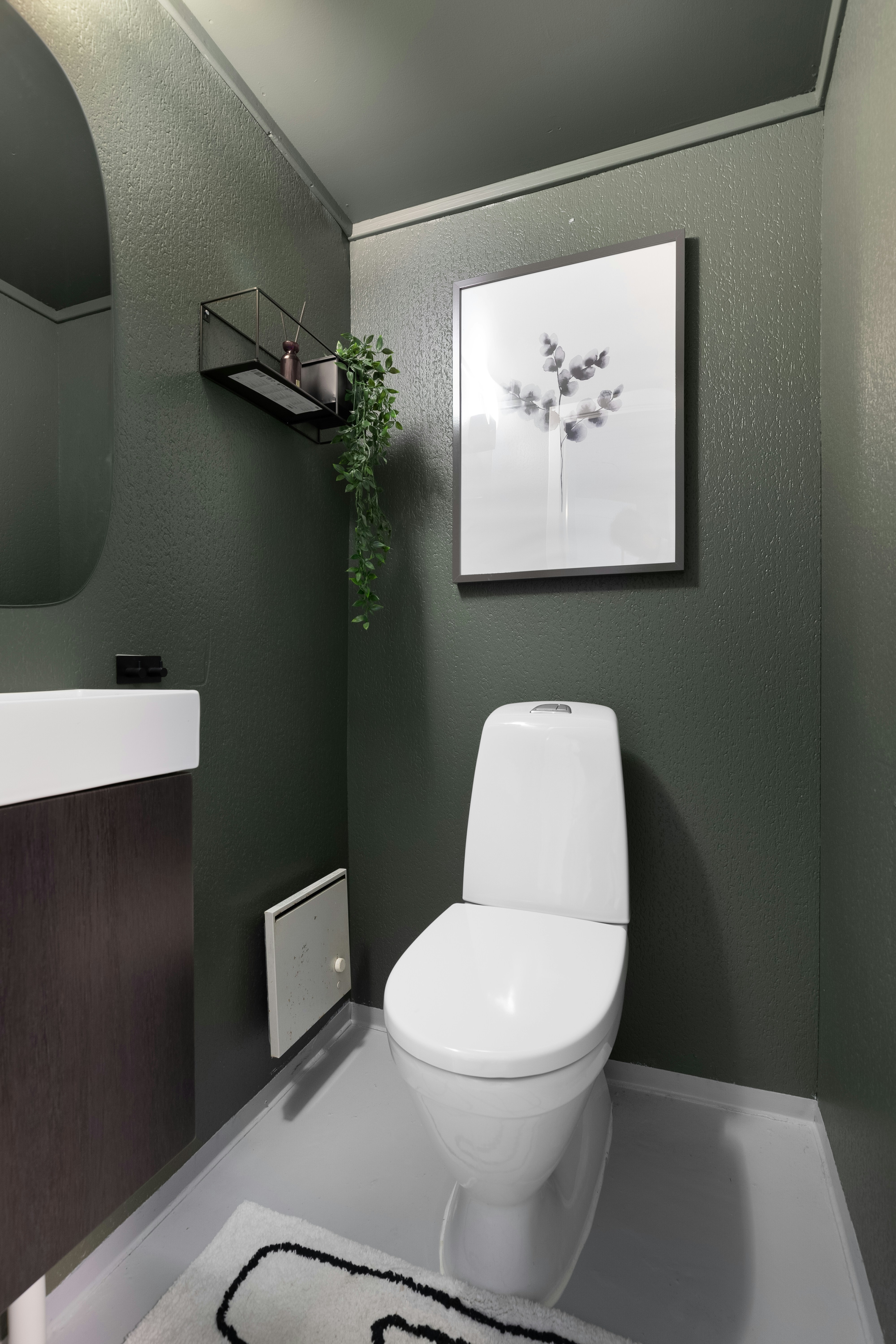 A white toilet sitting in a bathroom next to a sink