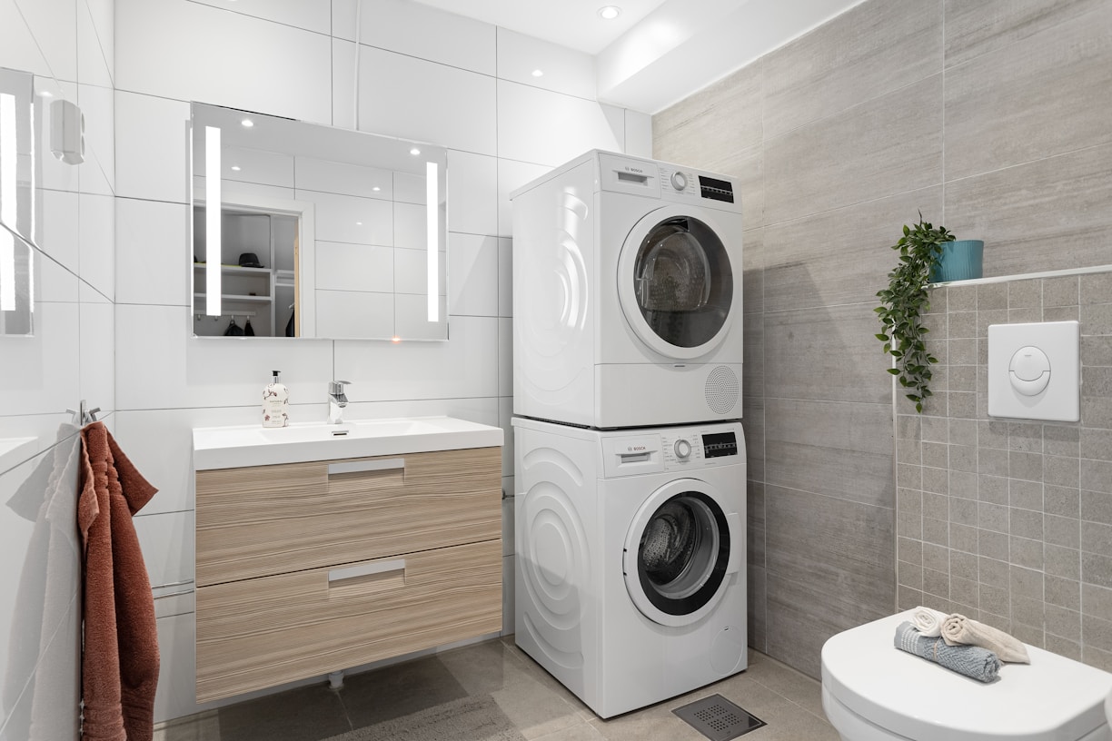 A bathroom with a washer and dryer in it