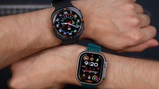 A couple of people that are holding onto some wrist watches