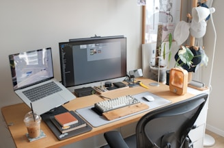 A desk with a laptop and a computer monitor